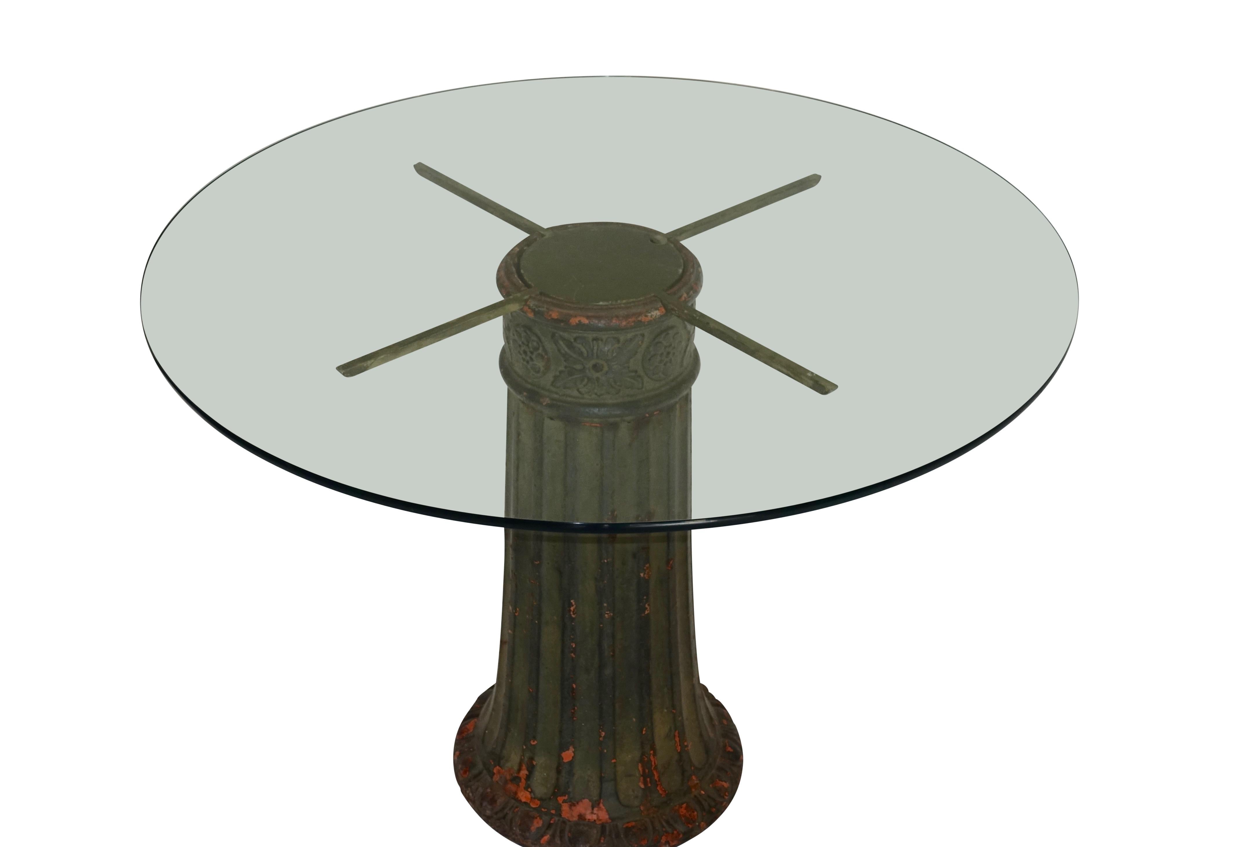 A late 19th-early 20th century San Francisco street light base with original verdigris painted finish converted to a dining or center table. Table comes with a bull nose edged 41 inch diameter glass top, but will accommodate up to a 52 inch