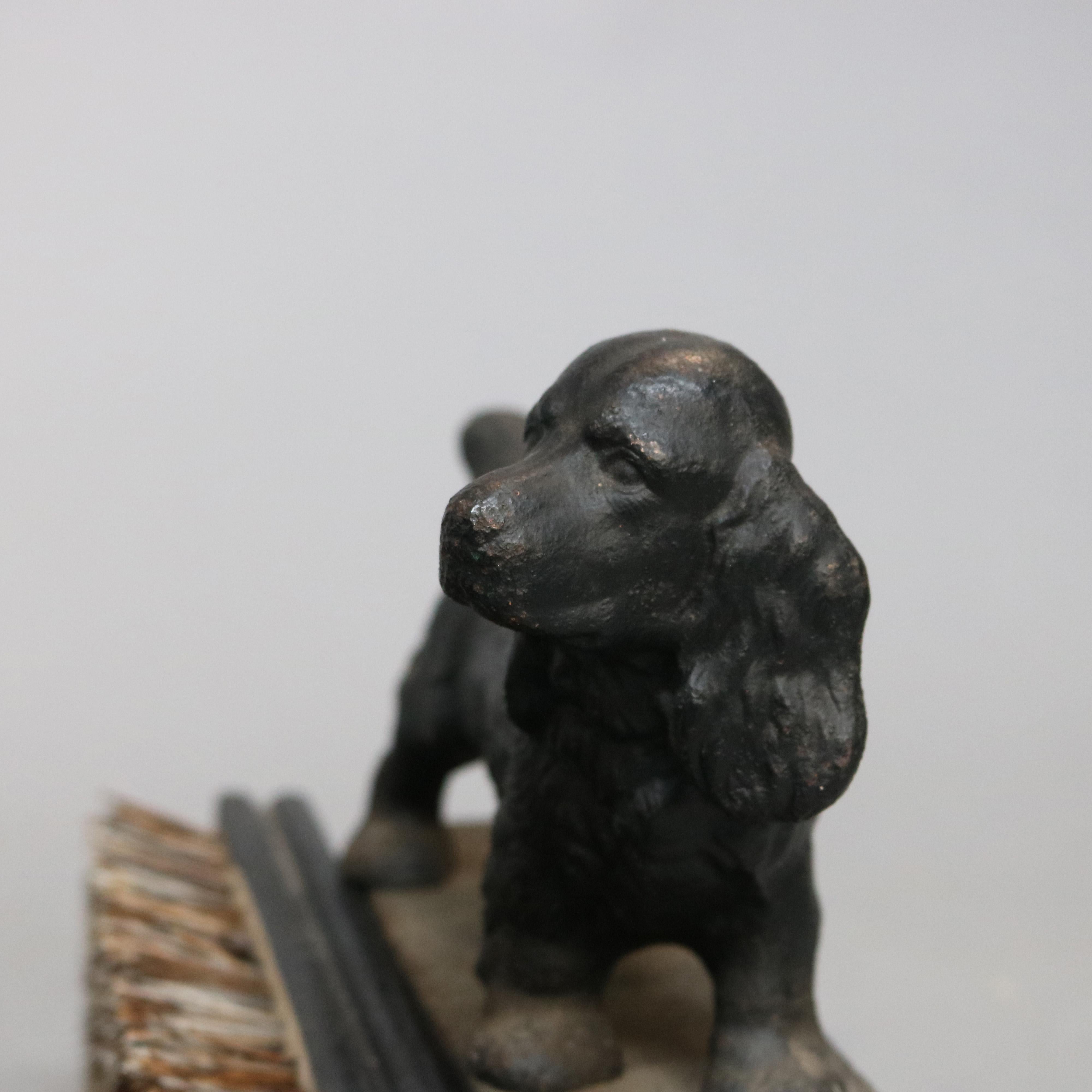 An antique figural boot scraper offers cast iron construction with flanking spaniels, circa 1890

Measures - 7.5