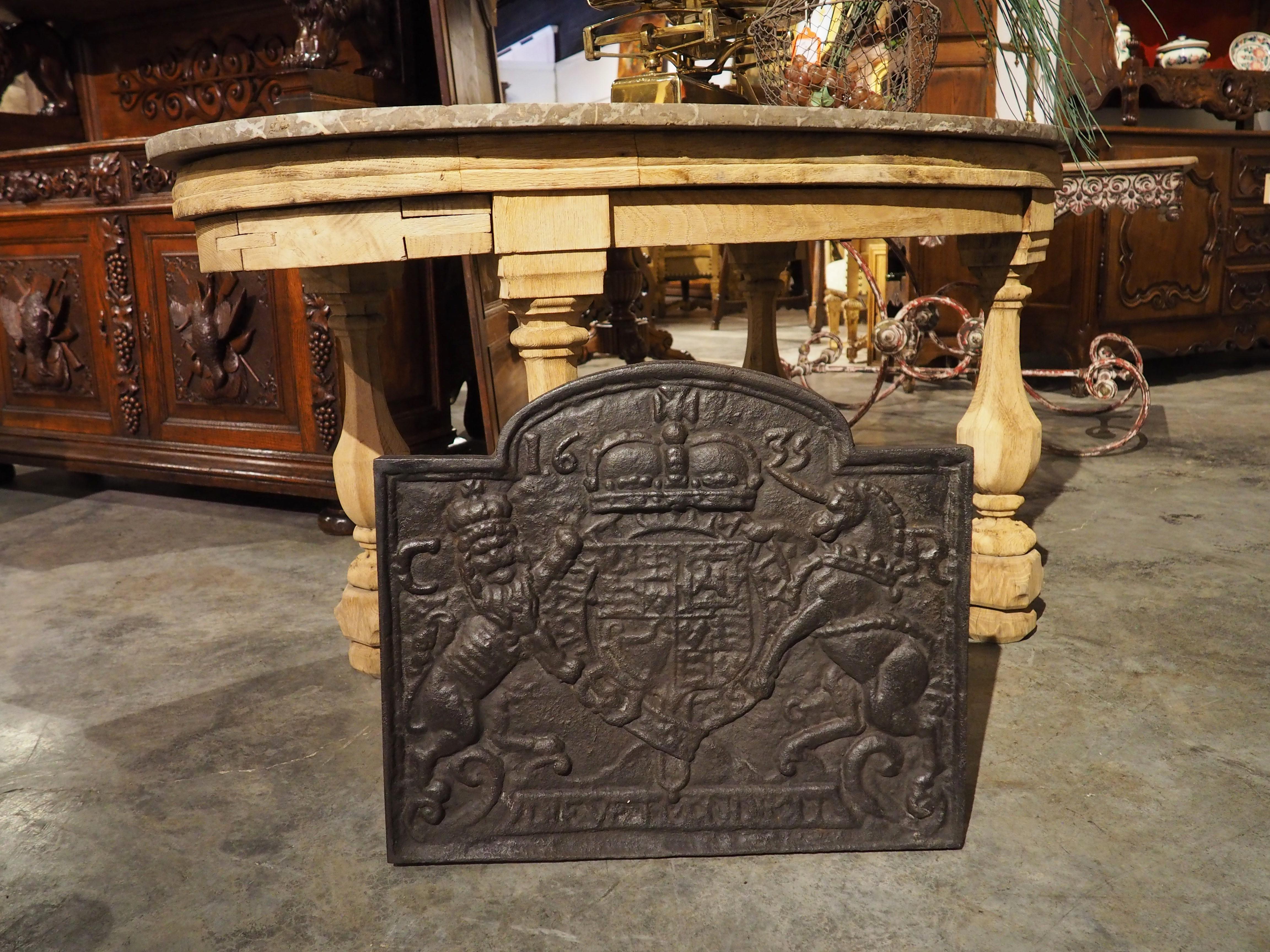 This antique cast iron fireback features the coat of arms of Charles I, King of England, Ireland, and Scotland from 1625-1649. It has recently been cleaned and lightly clear waxed to accentuate the motifs and provide a rich and even patina.

The