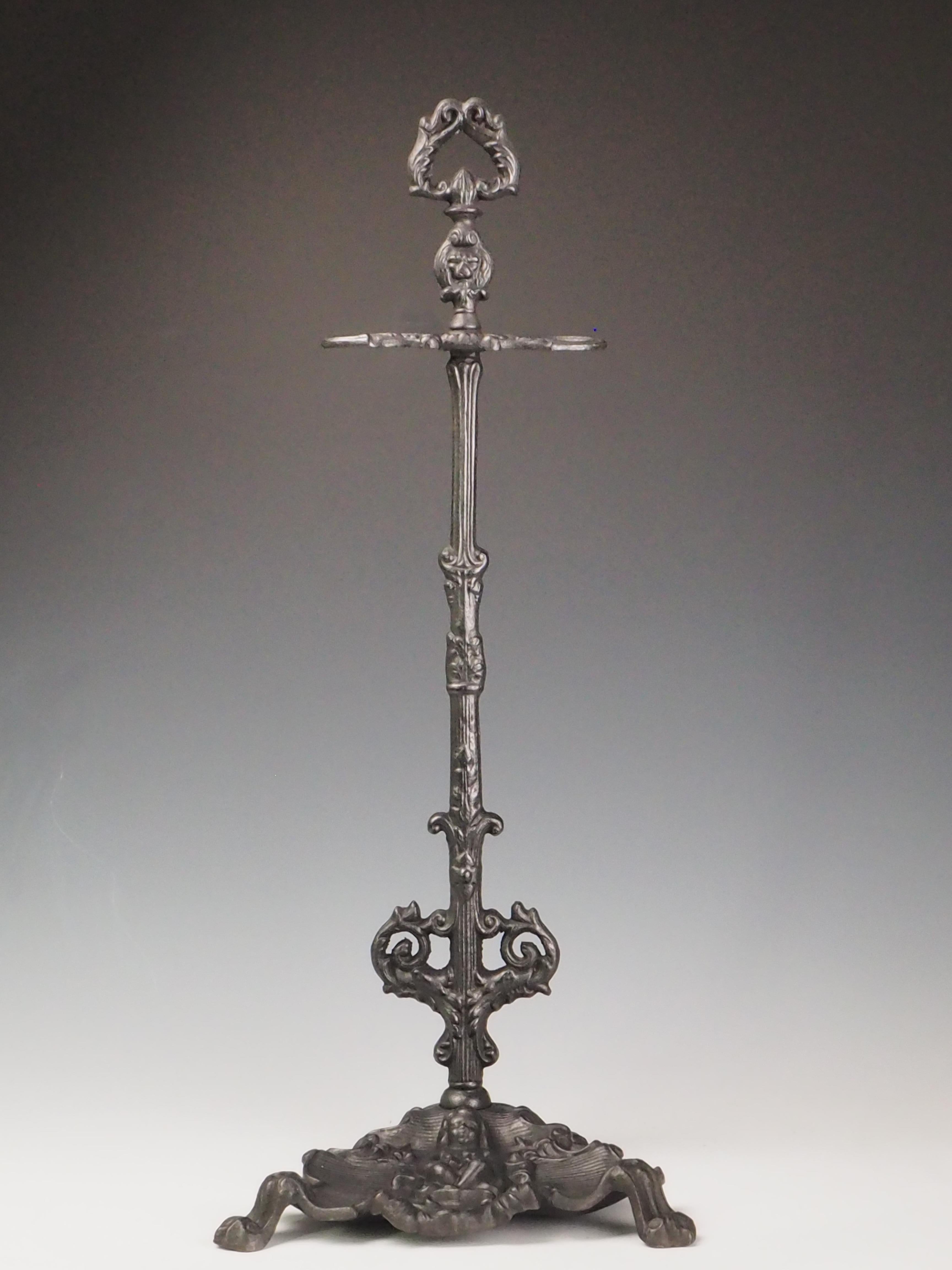 Antique Cast Iron Tool Stand  Cherub Design

Introduce a touch of historical elegance to your fireplace with this 19th-century antique cast iron tool stand. Featuring an intricately detailed cherub in its tray, the piece embodies the sophistication