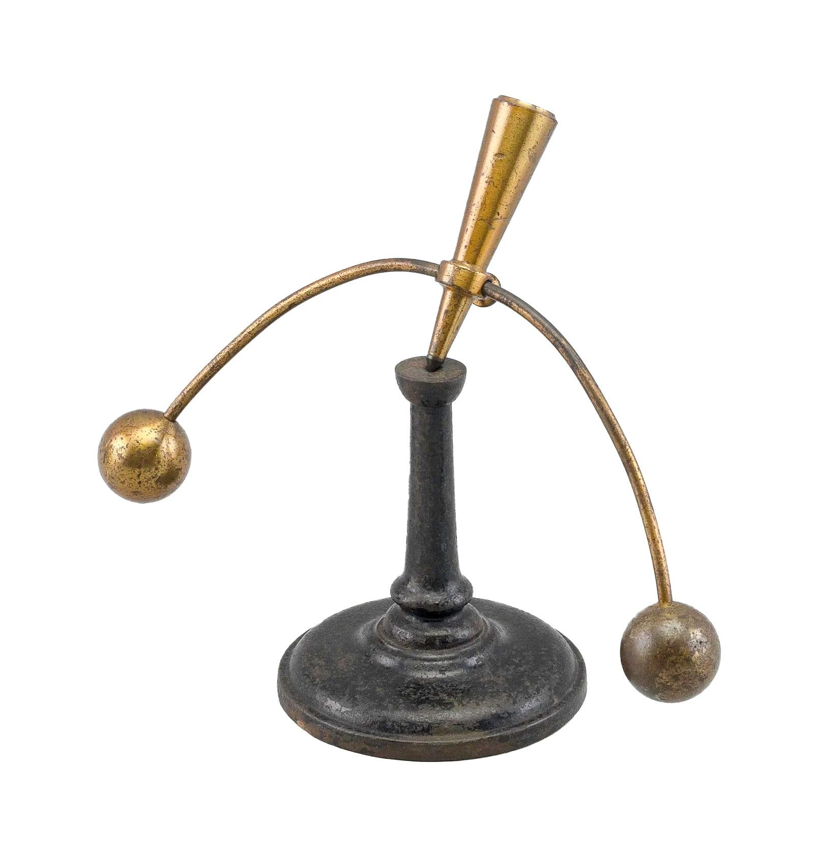 19th / 20th century didactic balance device, probably made for use in a physics laboratory or classroom. In the Style of Max Kohl (1853-1908), all in lacquered brass, a semi-circular rod passes through an inverted cone with a set-screw and has a
