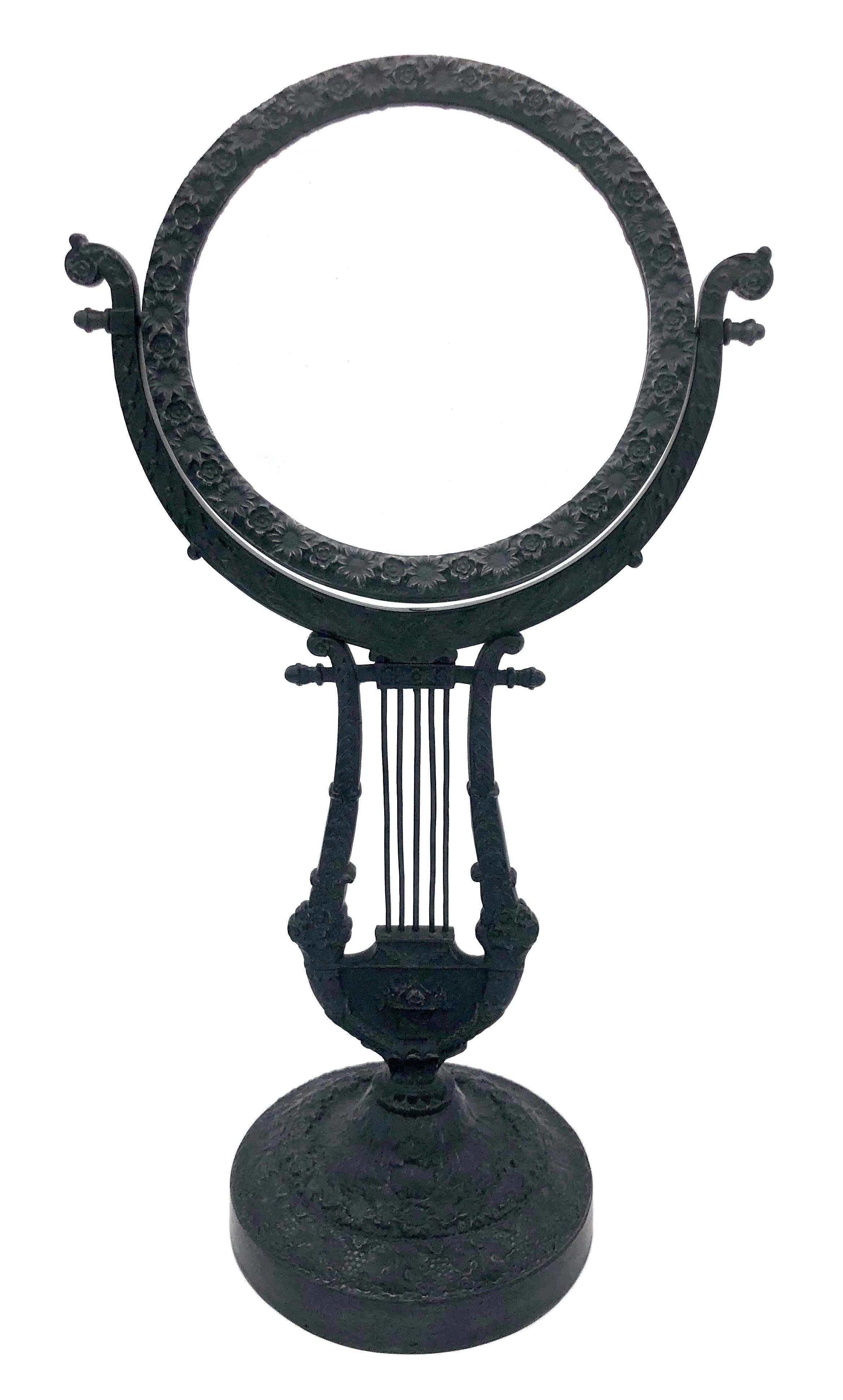 This very elegant revolving table mirror is made our of cast iron. It features the most intricate detailing and has retained it's original mirror glass.
It is decorated with different kind of leaves, oak leaves, grapes, vine, a variety of flowers,