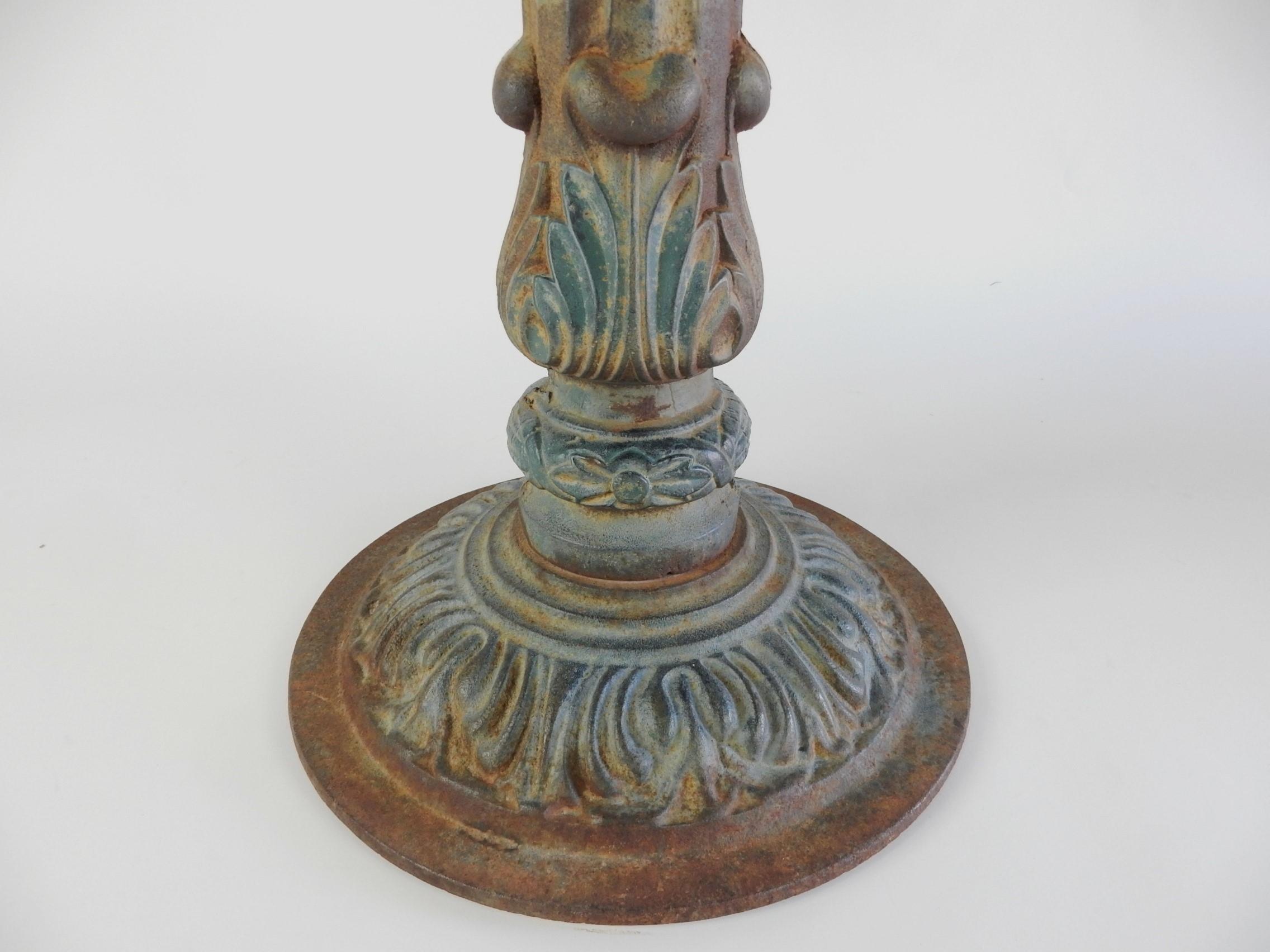 Solid cast iron bistro table base. (7 available at start of listing, priced per item). By Haasbrock-Sonderguard. 
Once painted a blueish green color but now with a marvelous true aged patina.
It's weight allows for a 36