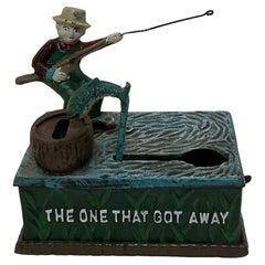 Antique Cast Iron Penny or Money Bank Boy Fishing Marked "The One That Got Away"