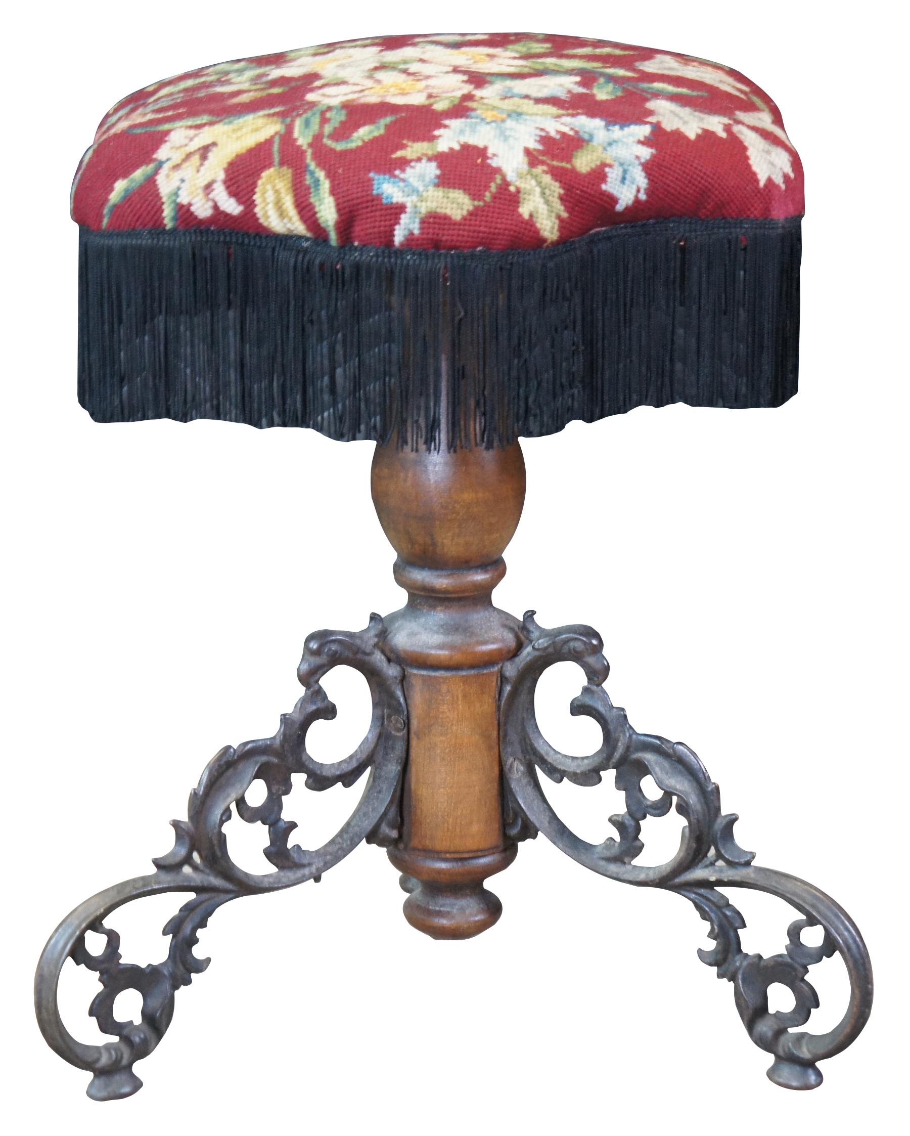 Antique 1880s adjustable piano stool featuring hexagon form with needlepoint & fringe seat, turned wood body and scrolled ornate tripod base with Phoenix / Griffon / Bird head accents.

Measures:17