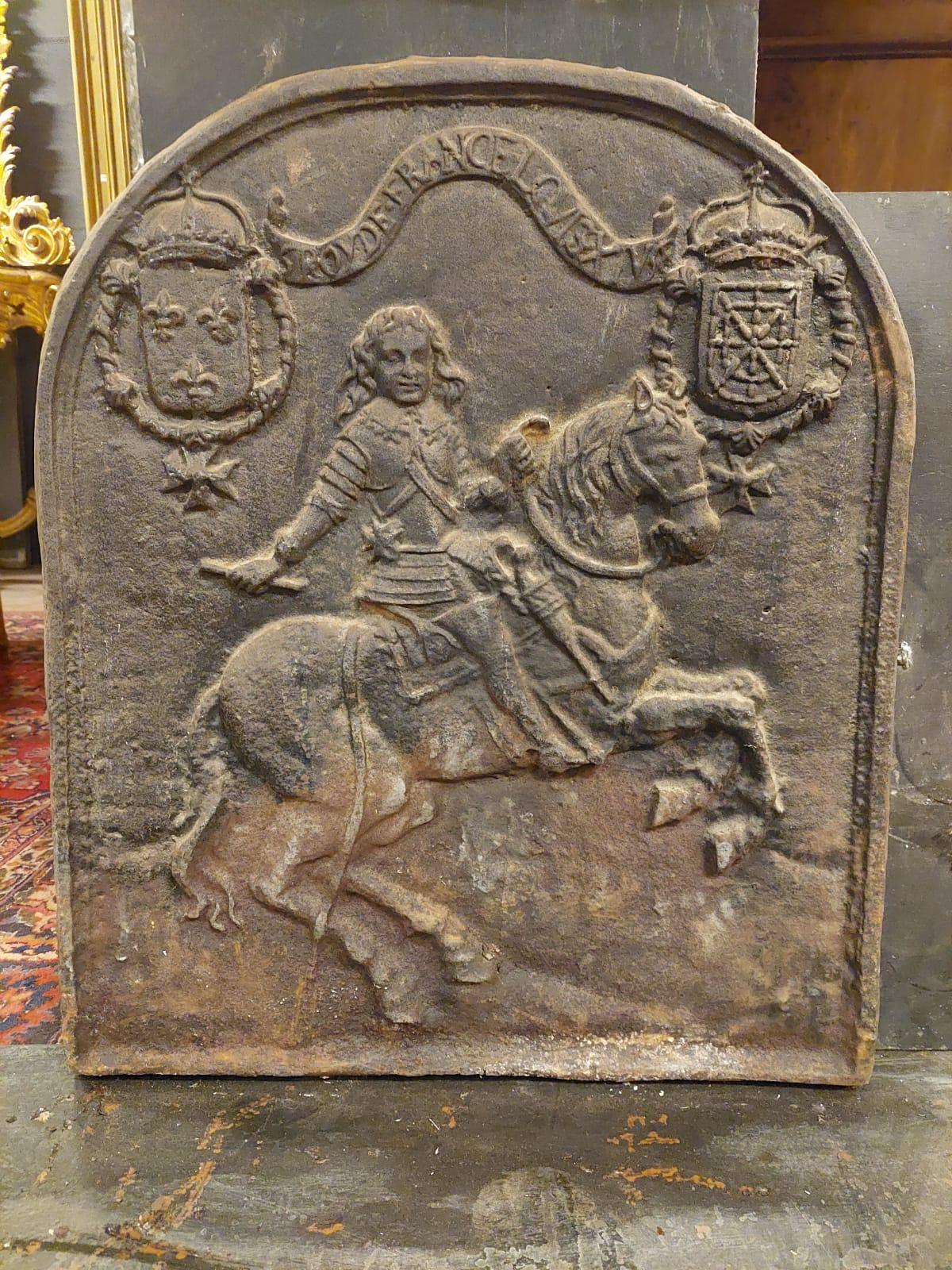 Antique cast iron plate representing the Sun King on horseback, with the inscription 