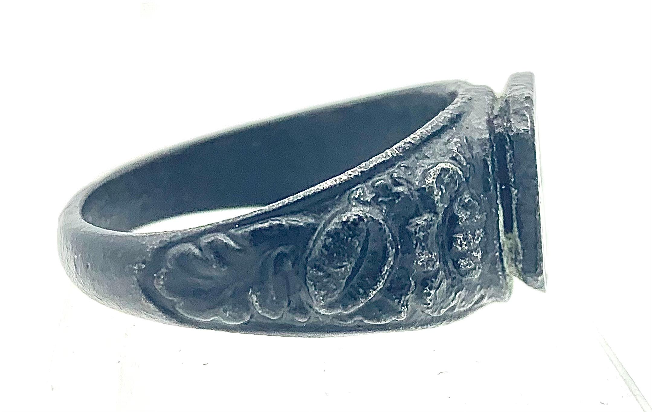 This unusual cast Iron signet ring features a finely designed bouquet of fruits and flowers in a high footed vase.
The ring shoulders are decorated with flowers and leaves.