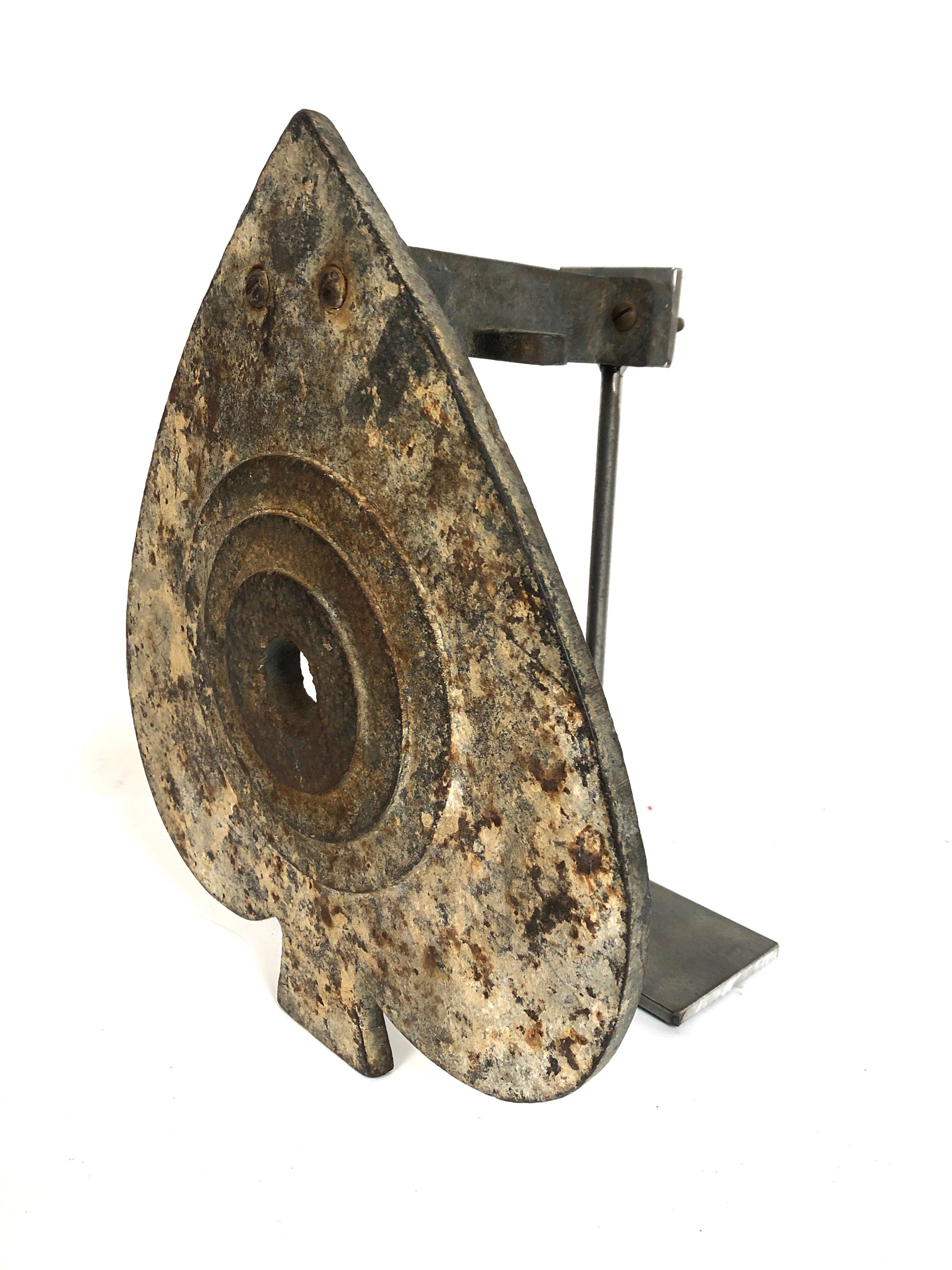 A custom mounted antique cast iron shooting gallery target in the form of a spade. Raised concentric circle pattern. Original untouched surface with remains of white paint. No cracks or breaks.