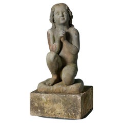 Statue ancienne en fonte d'un enfant priant