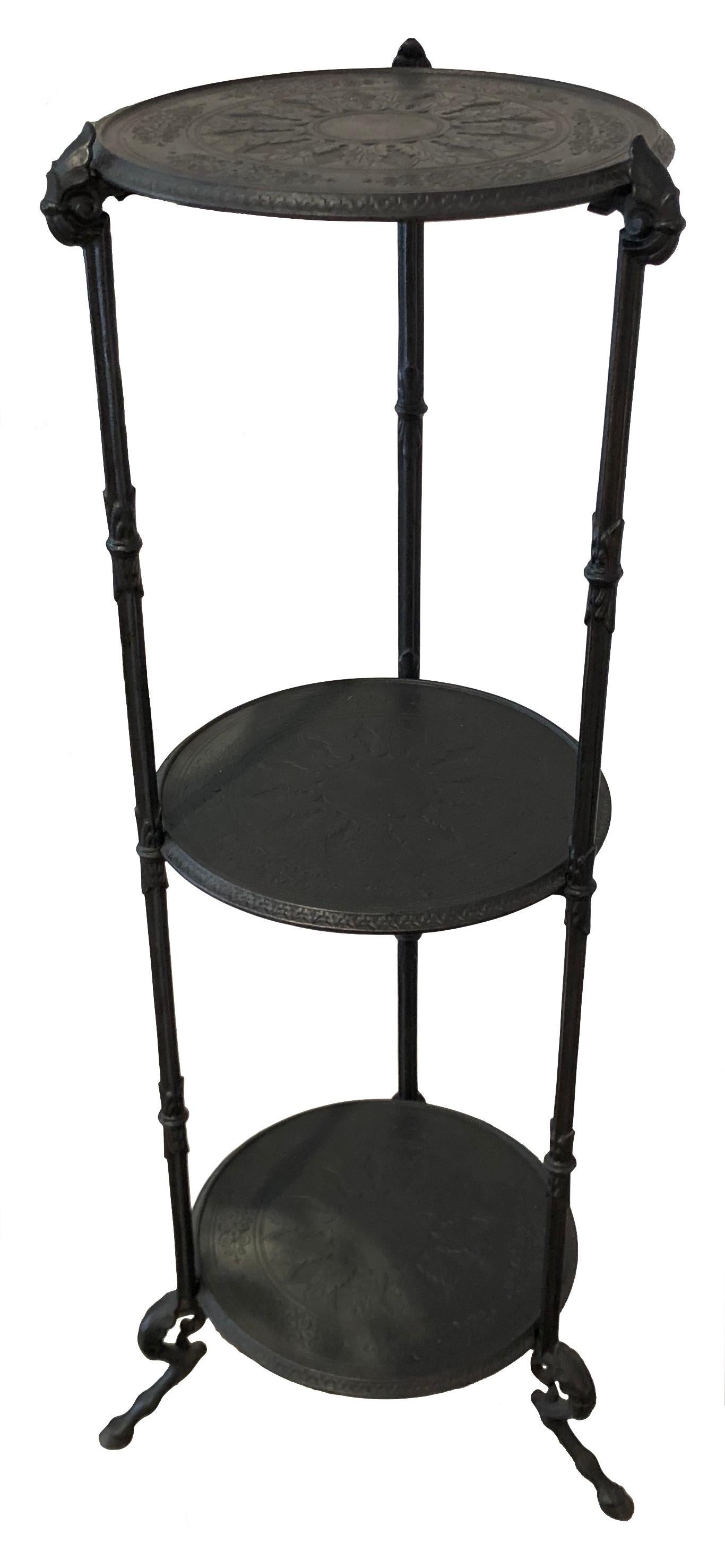 This elegant and versatile cast iron tripod side table doubles as an étagère. It features finely modelled goats feet.
The diametre of the three iron discs meassures 24.5cm. 