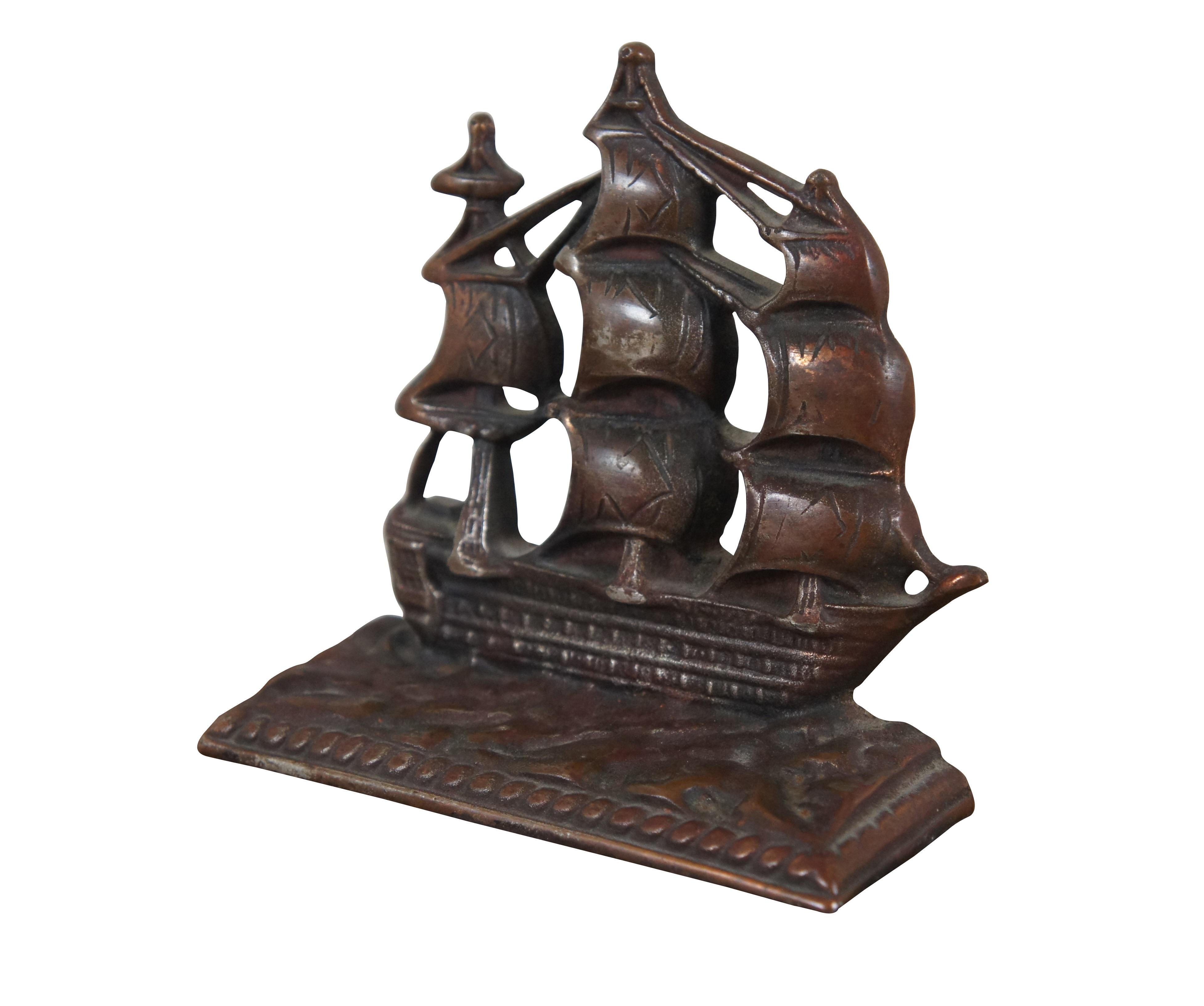 Antique ironside with a bronzed finish, depicting the United States Naval frigate / galleon / clipperThe Constitution on a rectangular base.

