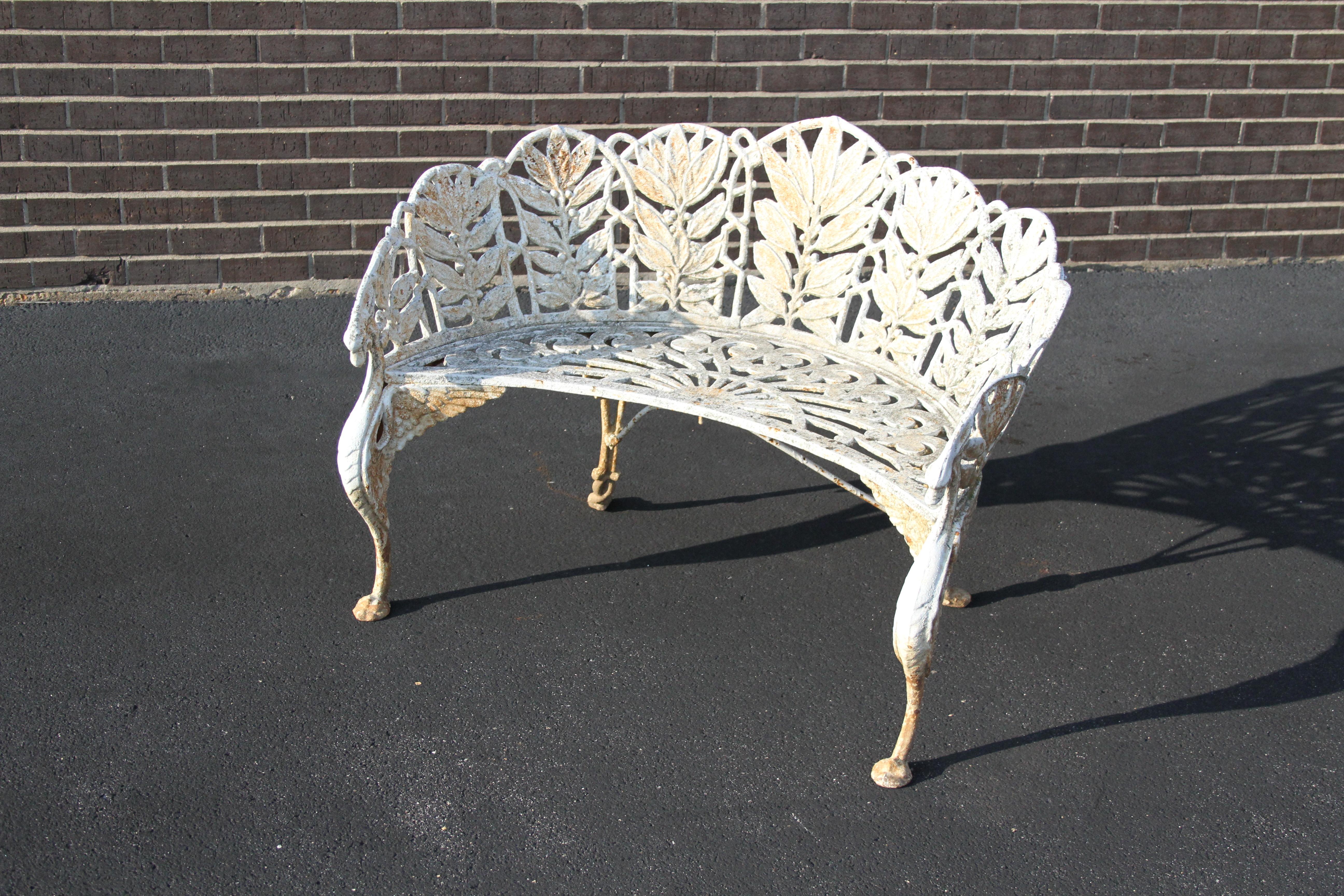 Antique heavy cast iron Victorian English garden bench painted white having the Laurel pattern with Griffin details. From an old St.Louis estate, paint show age and soil, can be blasted and repainted for additional cost. Free from damage, or missing