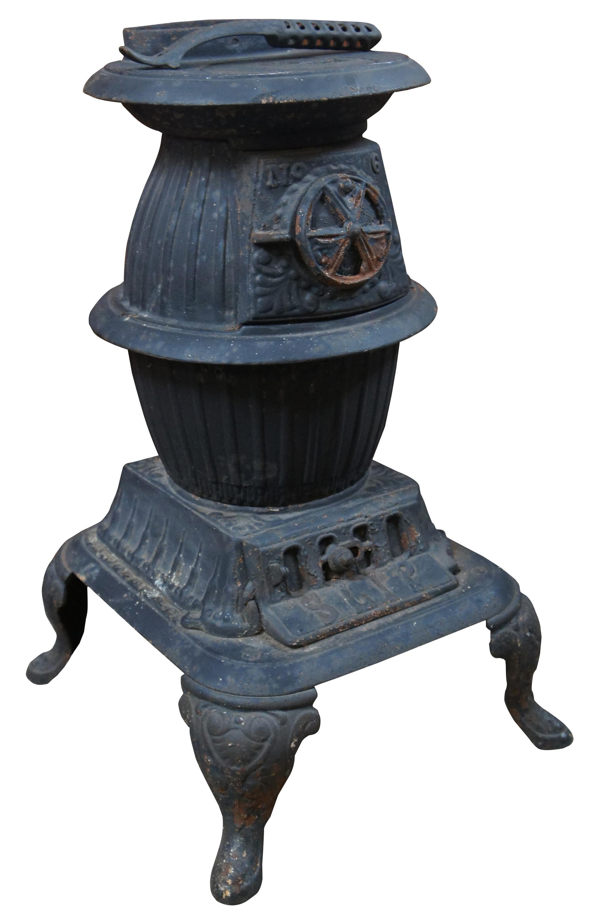 Small antique 19th century cast iron pot belly stove including flat iron and stove hook for the burner, sized for use in a railroad station or other small room. Marked slip on the lower plate, no 6.

Measures: Lid hook 8.75” x 0.75” x 1”, iron