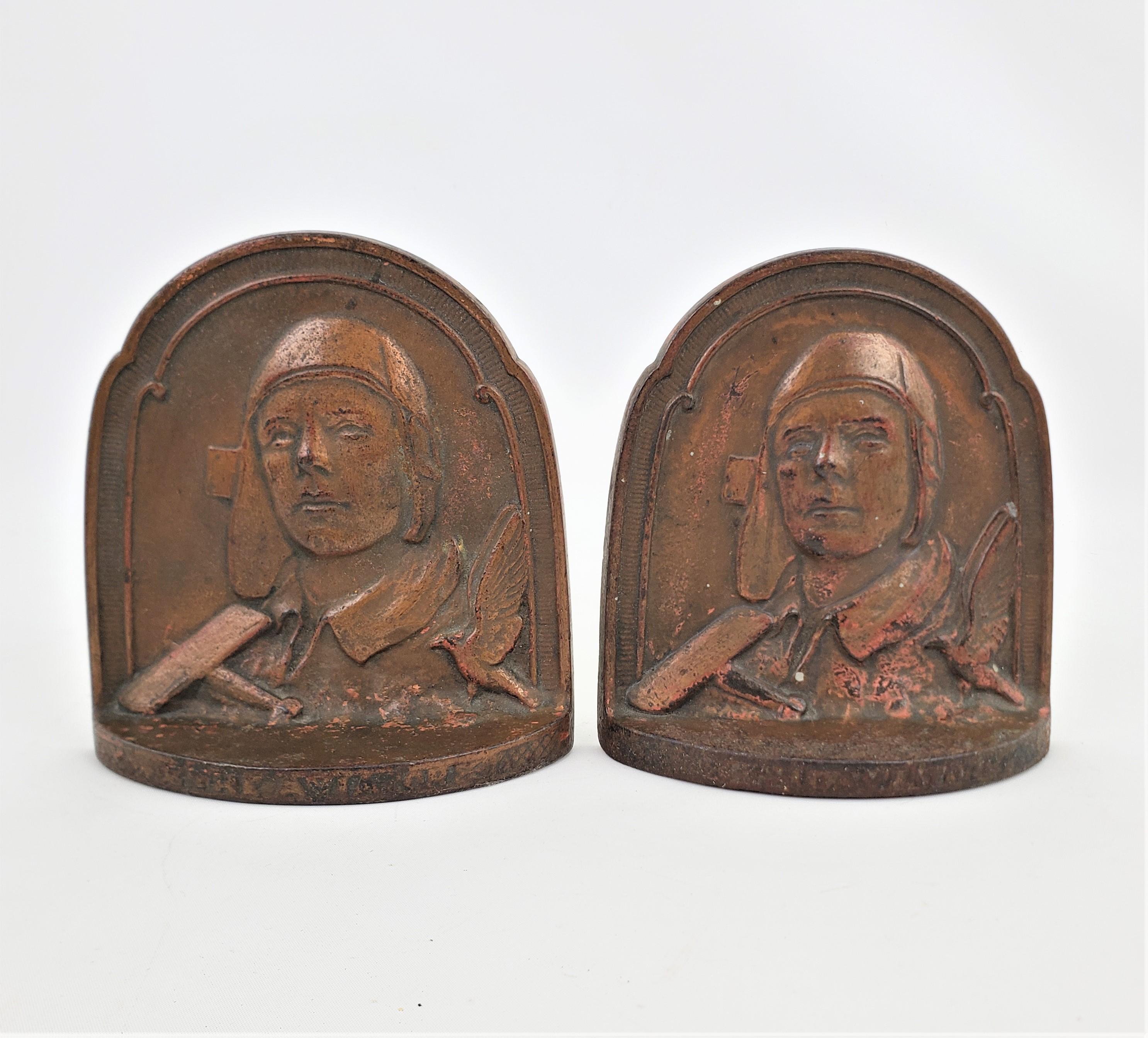 This set of cast and patinated bookends are signed by an unknown maker, but presumed to be early examples made by COPR of the United States during the 1920's in the period Art Deco style. The bookends show a relief depicting Charles Lindbergh with