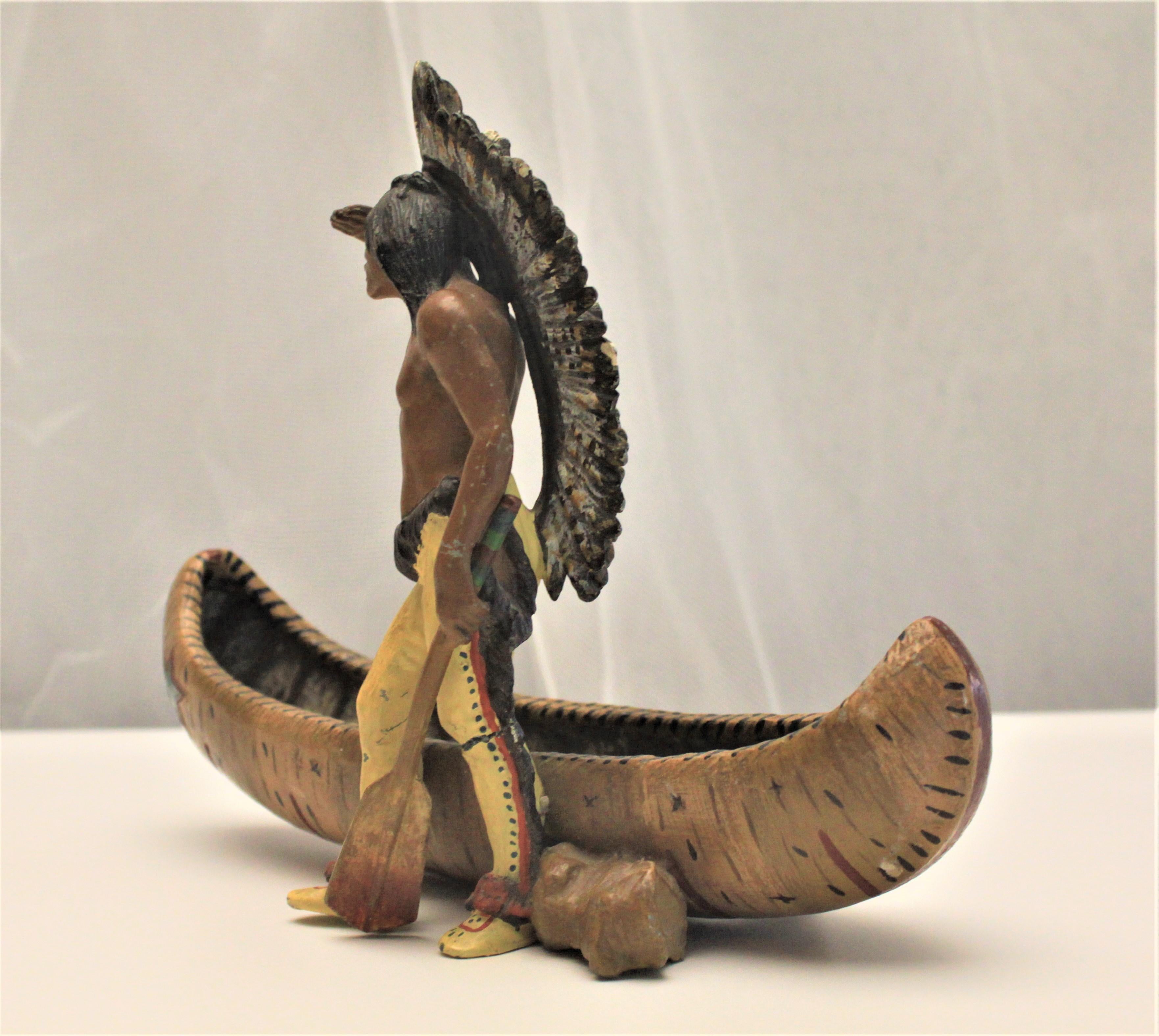 Native American Antique Cast Metal and Cold Painted Native Indian and Canoe Figurine