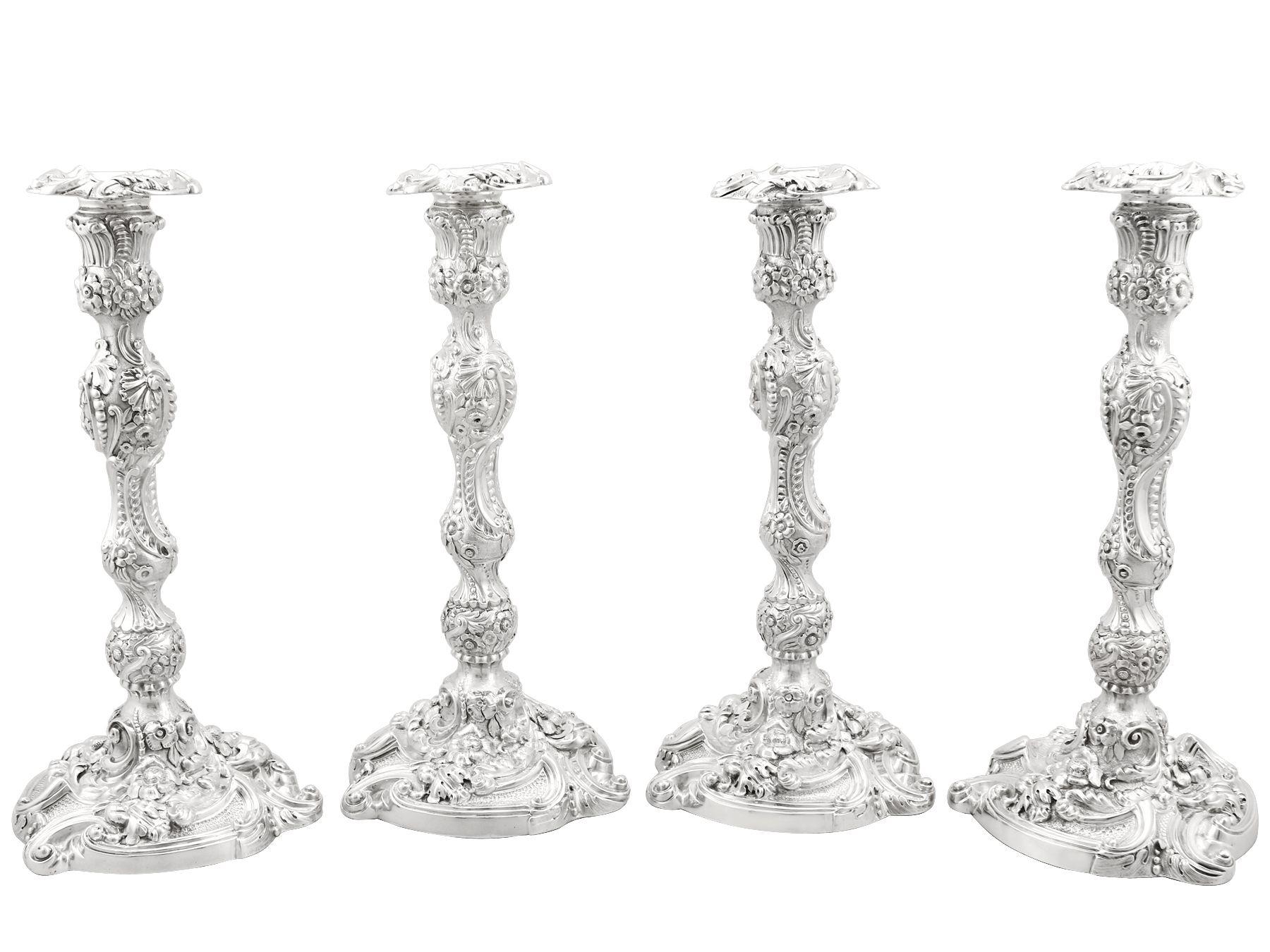 A magnificent, fine and impressive, set of four antique George IV English sterling silver candlesticks; an addition to our antique silverware collection.

These magnificent antique George IV cast sterling silver candlesticks have a baluster shaped
