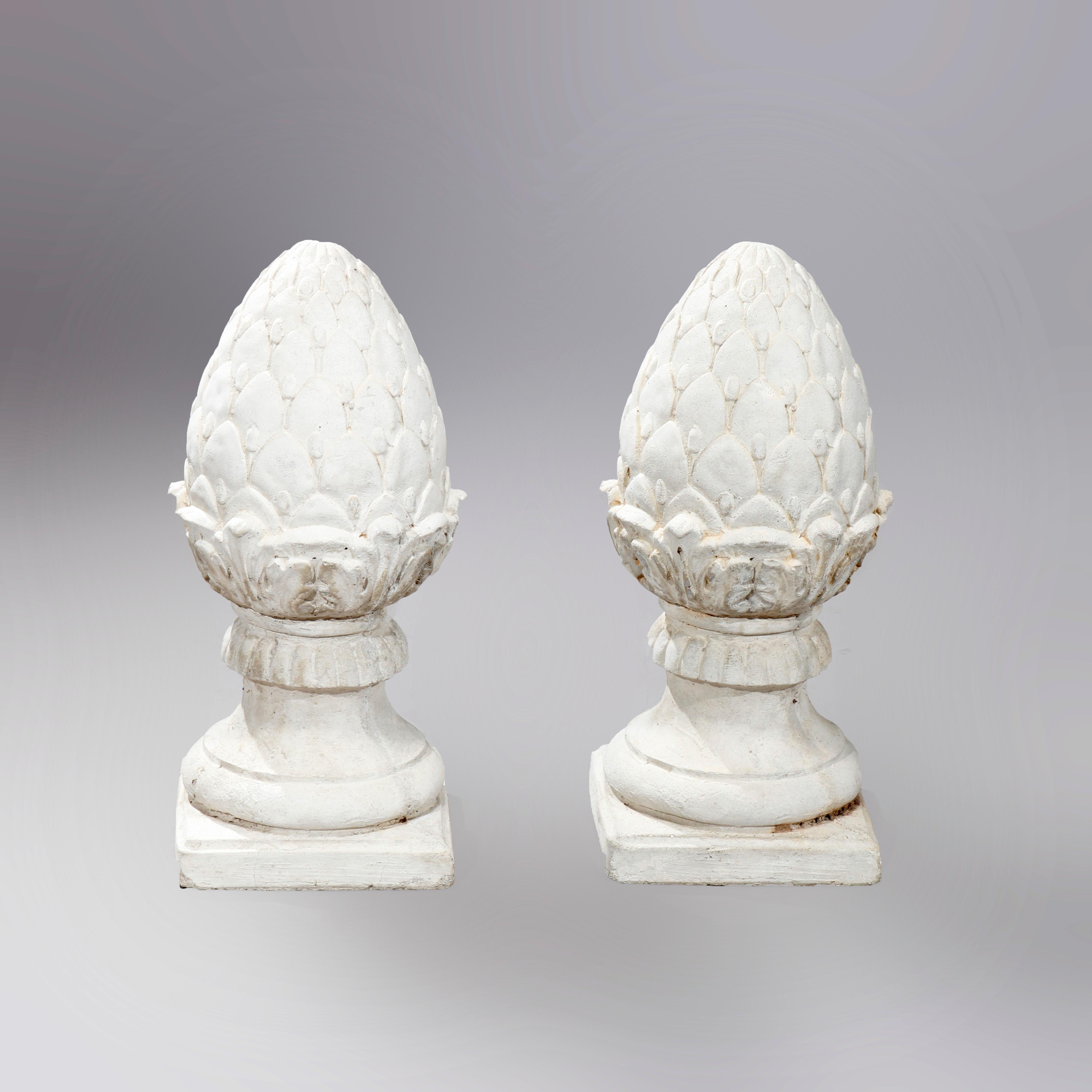A pair of antique garden finials offer cast stone construction in acorn or artichoke form seated on square bases, 20th century

Measures: 19