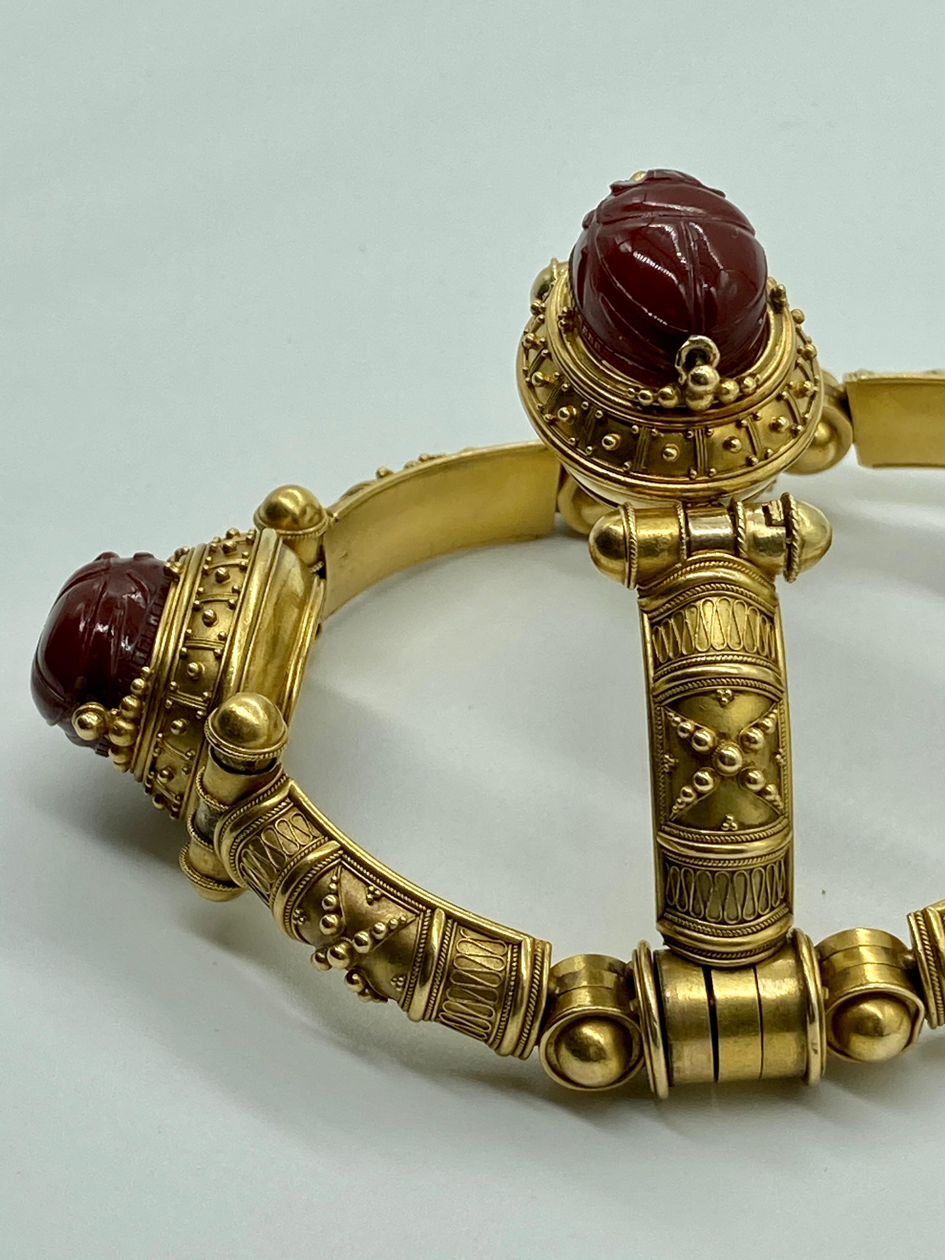 An antique Egyptian Revival bracelet circa 1870 by the Italian master jeweler Castellani. Featuring rotating carved carnelian scarabs with intaglios on their reverse and granulation detail on the 18 karat yellow gold body.