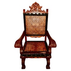 Fauteuil ancien en acajou sculpté et cuir gaufré de Castille