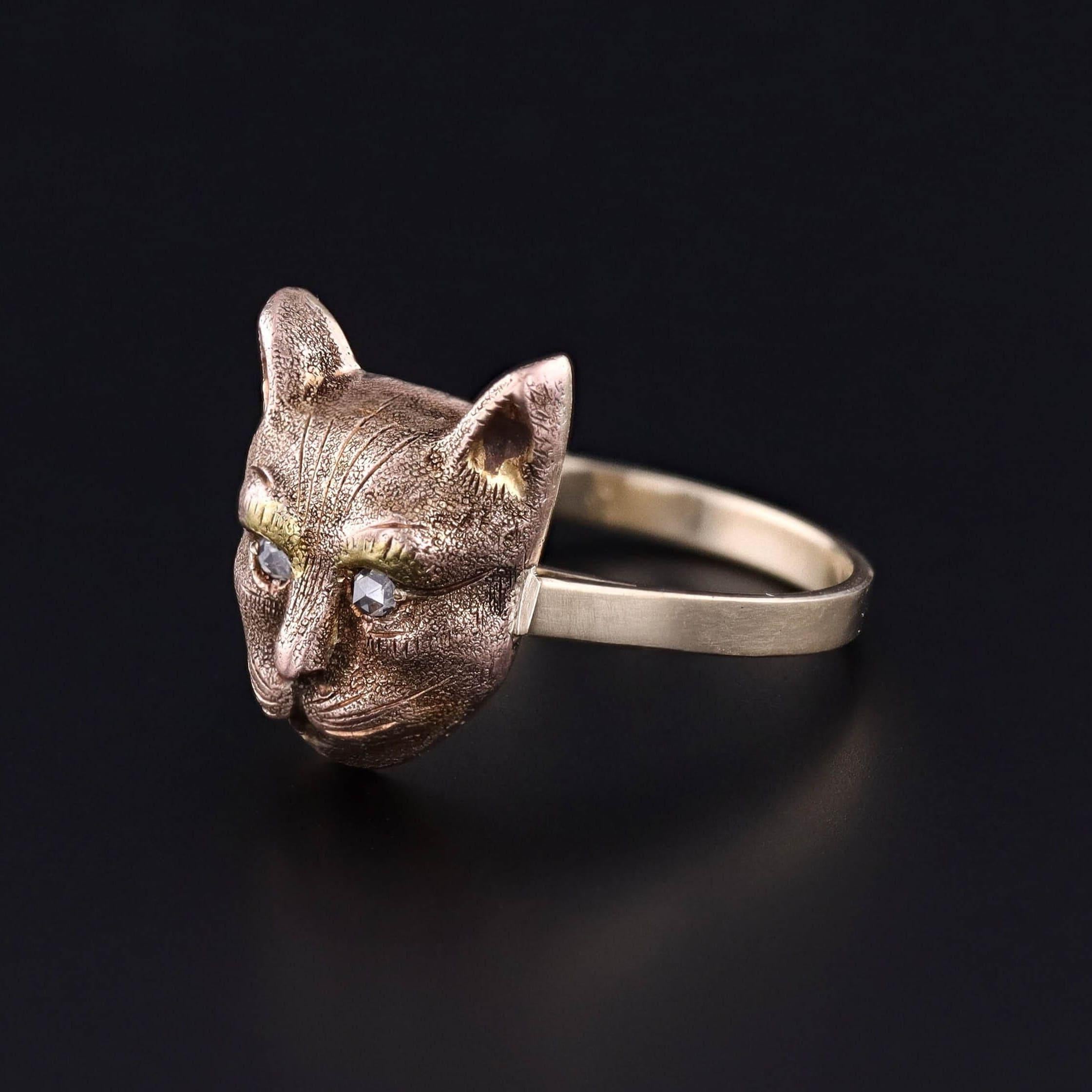 Antique Cat Ring: This 14k gold ring features a cat's head with two rose cut diamond eyes. It was originally an antique stickpin (circa 1890) that our jeweler transformed by removing the pin and adding a 14k gold band.

The face of the ring measures