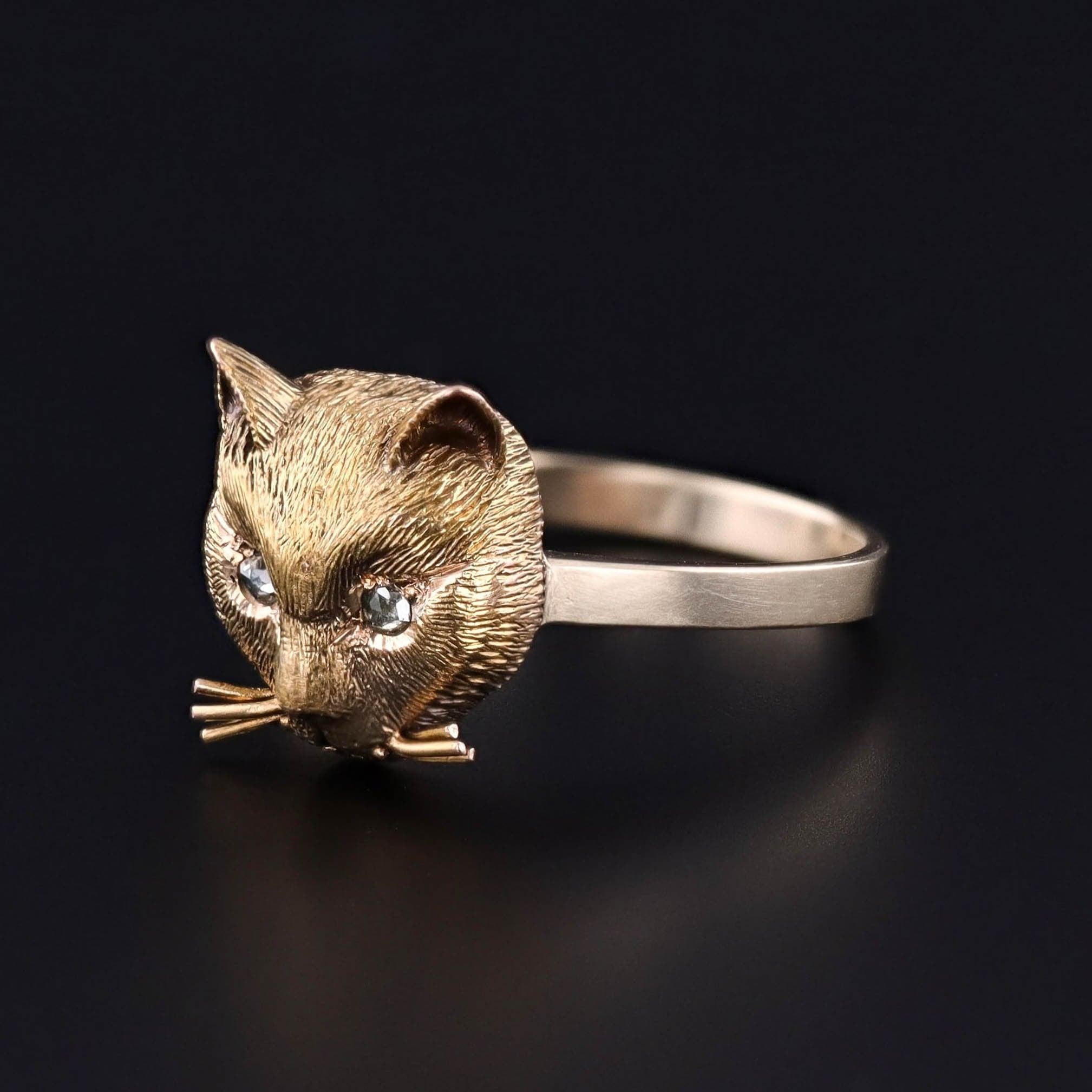 Antique Figural Cat Ring: This 14k gold ring features a cat's head with whiskers and two rose cut diamond eyes. It was originally an antique stickpin (circa 1890-1900) that our jeweler transformed by removing the pin and adding a 14k gold band.

The