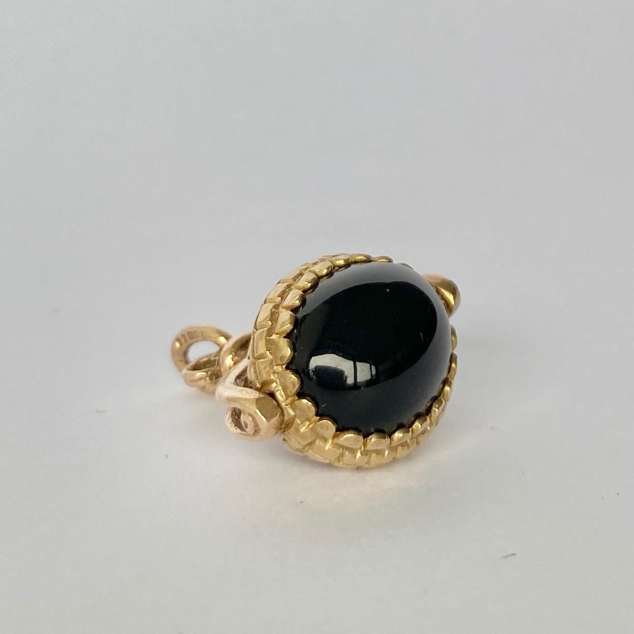 This sweet fob holds a cats eye and onyx stone that are rounded and smooth. The stones spin and have a decorative frame modelled in 9ct gold. Hallmarked London 

Fob height inc loop: 27mm

Weight: 6.65g