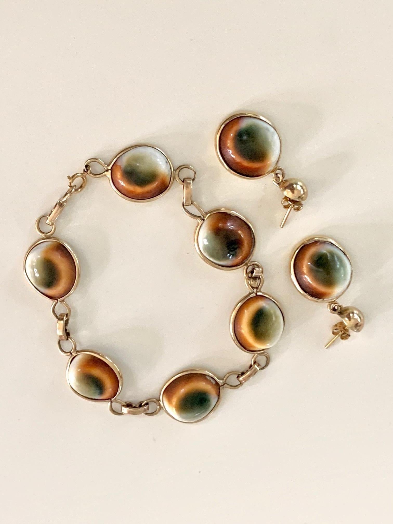 This bracelet and earring set are made from Operculum Snail shells.  It's easy to how they get their 