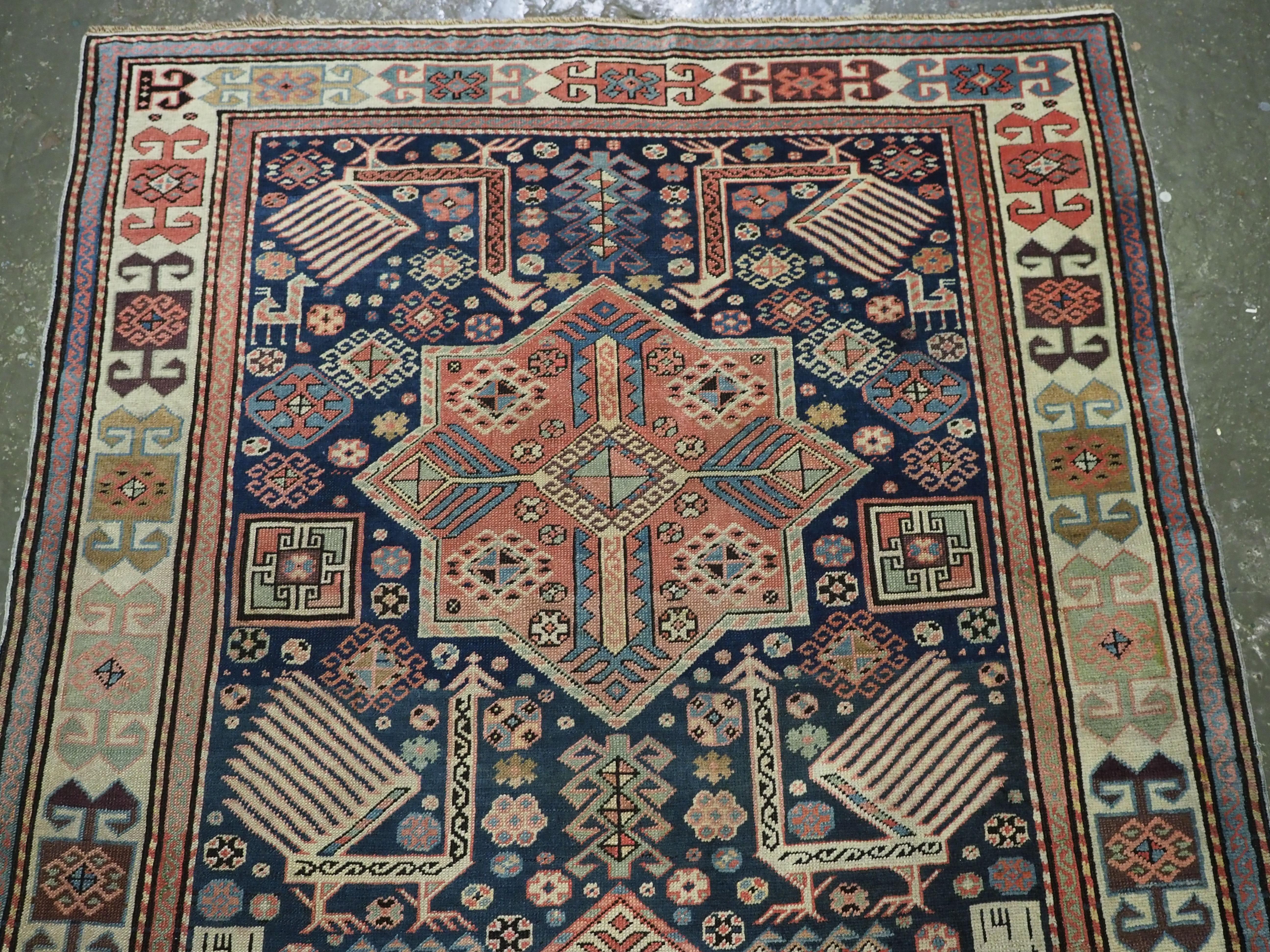 Size: 8ft 6in x 4ft 0in (259 x 123cm).

Antique Caucasian Akstafa long rug with three star medallions and eight large peacocks.

Circa 1880.

This is a good example of a well known group of long rugs attributed to the town of Akstafa. This rug is of
