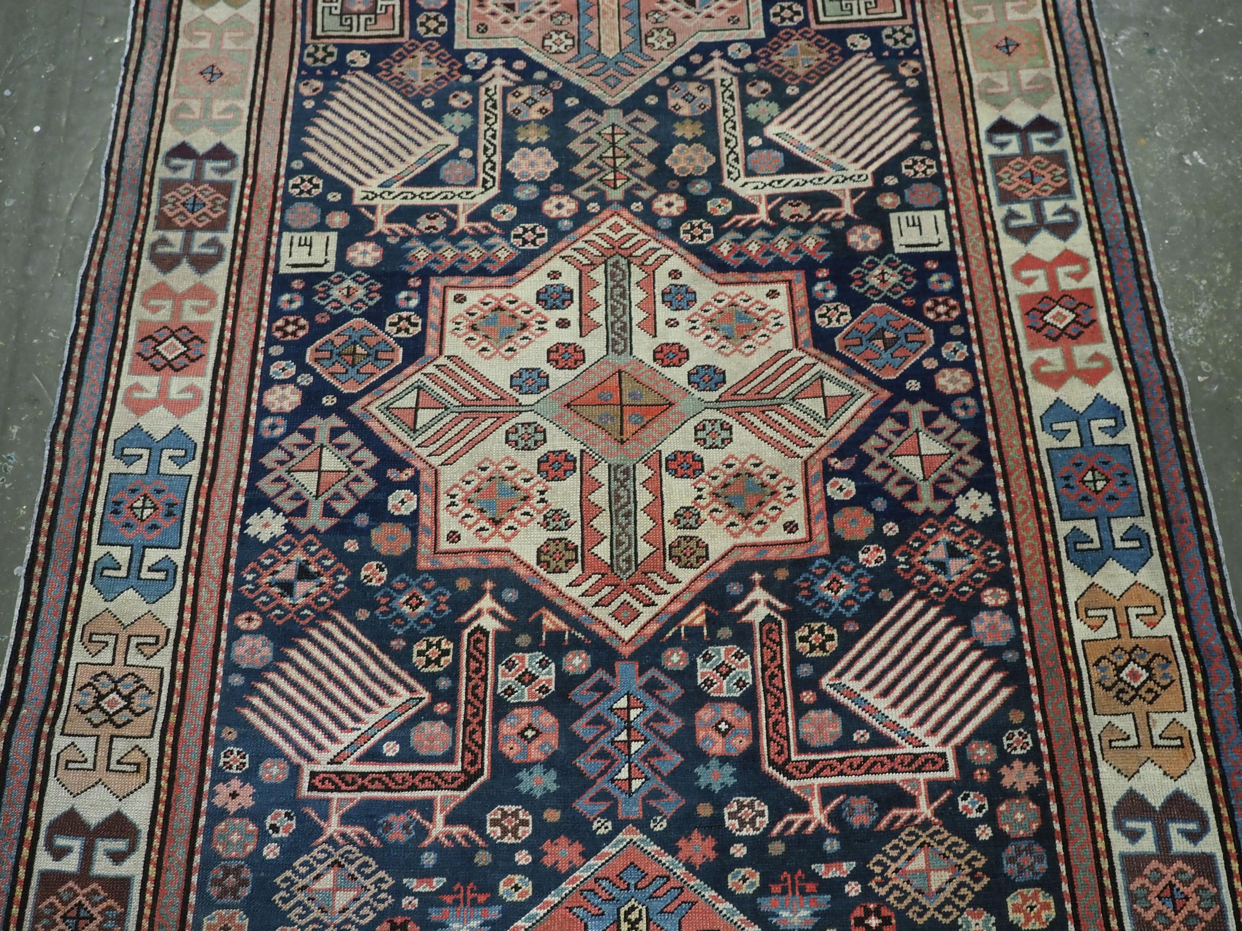Asian Antique Caucasian Akstafa long rug with three star medallions, circa 1880. For Sale