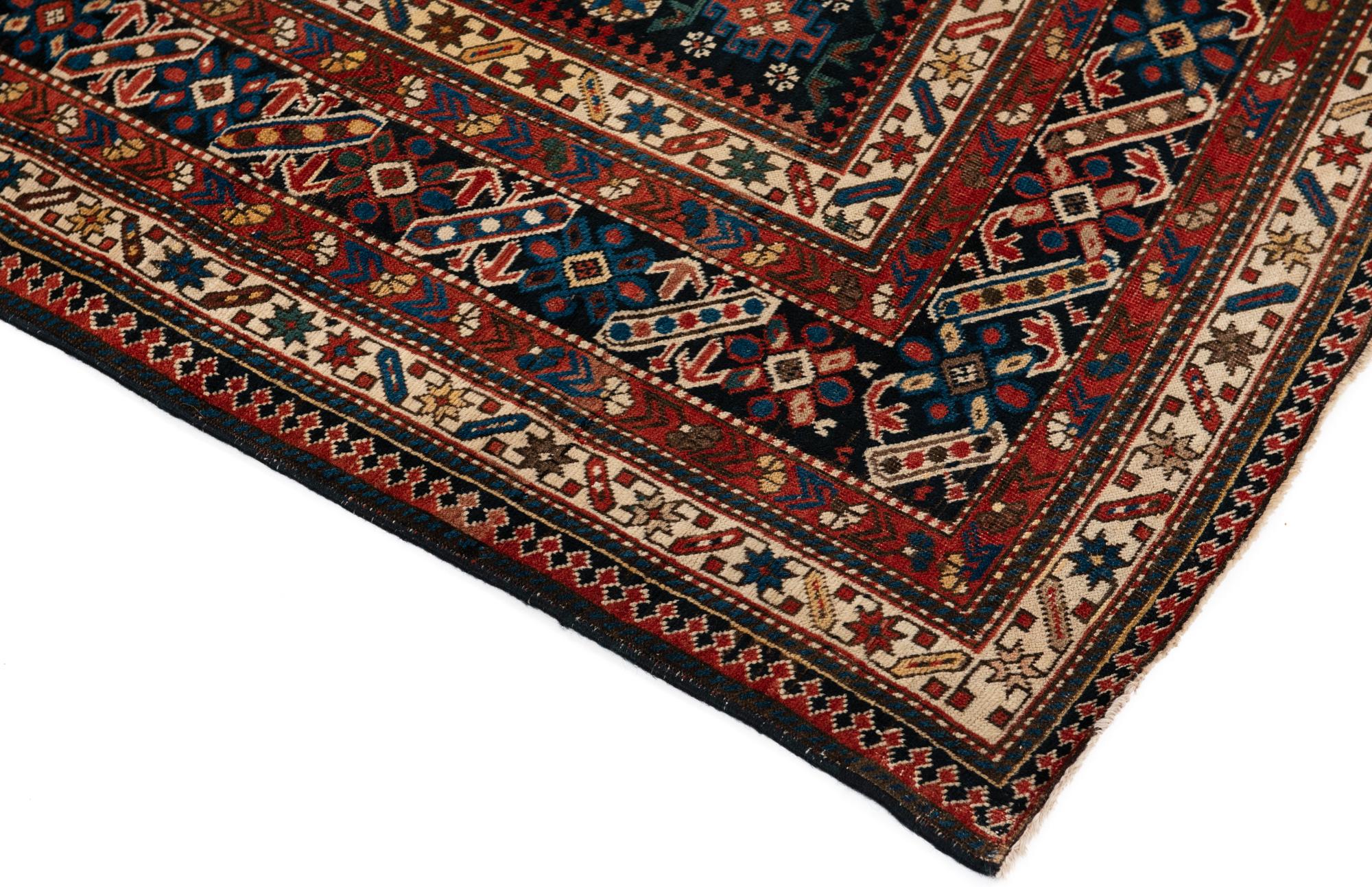 This is a fine example of Northeastern Caucasian rugs from the Kuba district known as Chi-Chi, woven circa 1880. It has a wonderfully intricate main border and matching three minor borders on either side divided by narrower borders adding more