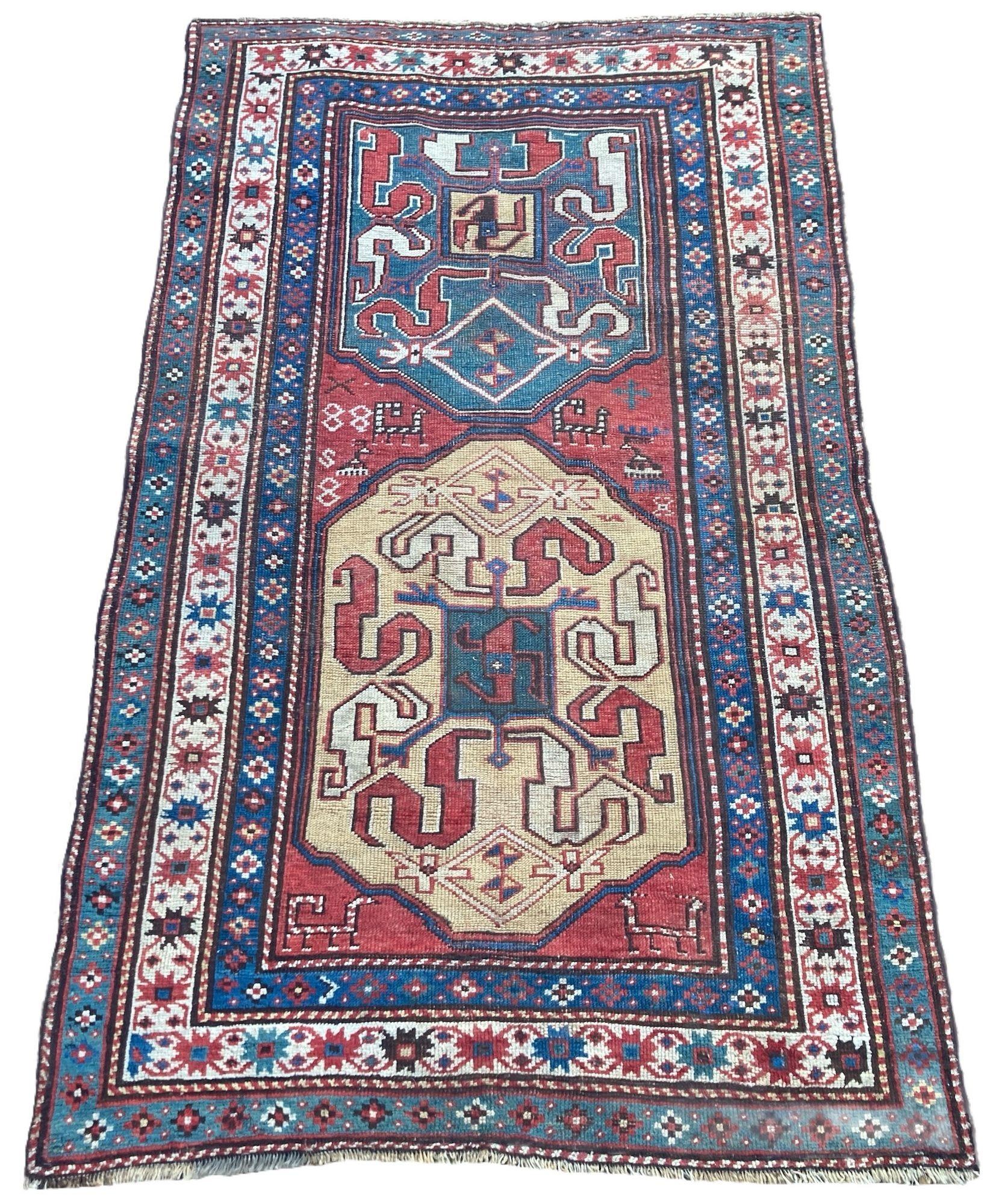 A wonderful antique Caucasian rug, hand woven in the late 19th Century near the village of Khndzoresk in modern day Armenia. The rug features two large medallions with the iconic ‘cloudband’ design on a terracotta red field and ivory border. Note