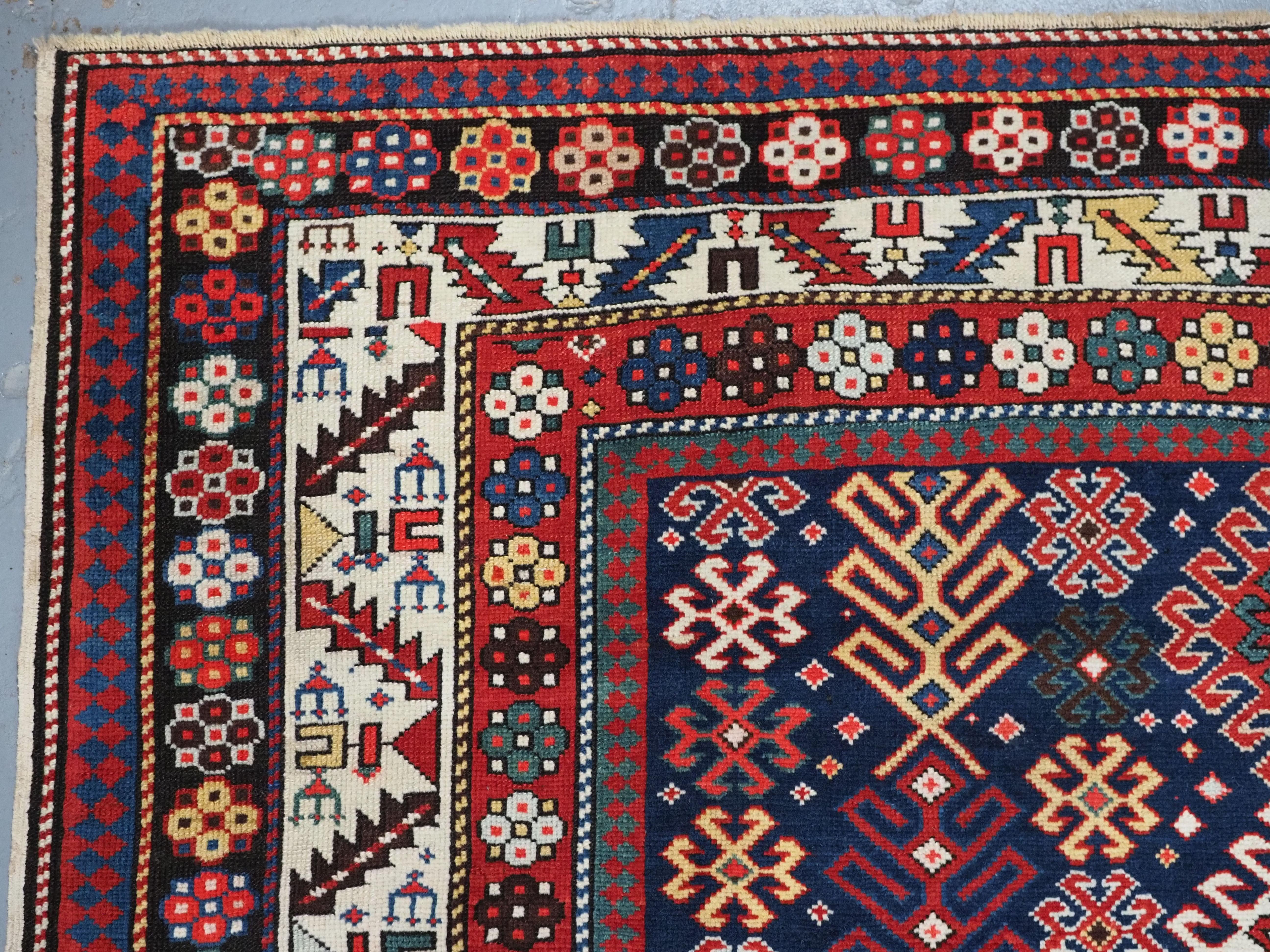 Wool Antique Caucasian Dagestan long rug with hooked medallion design.  Circa 1890. For Sale