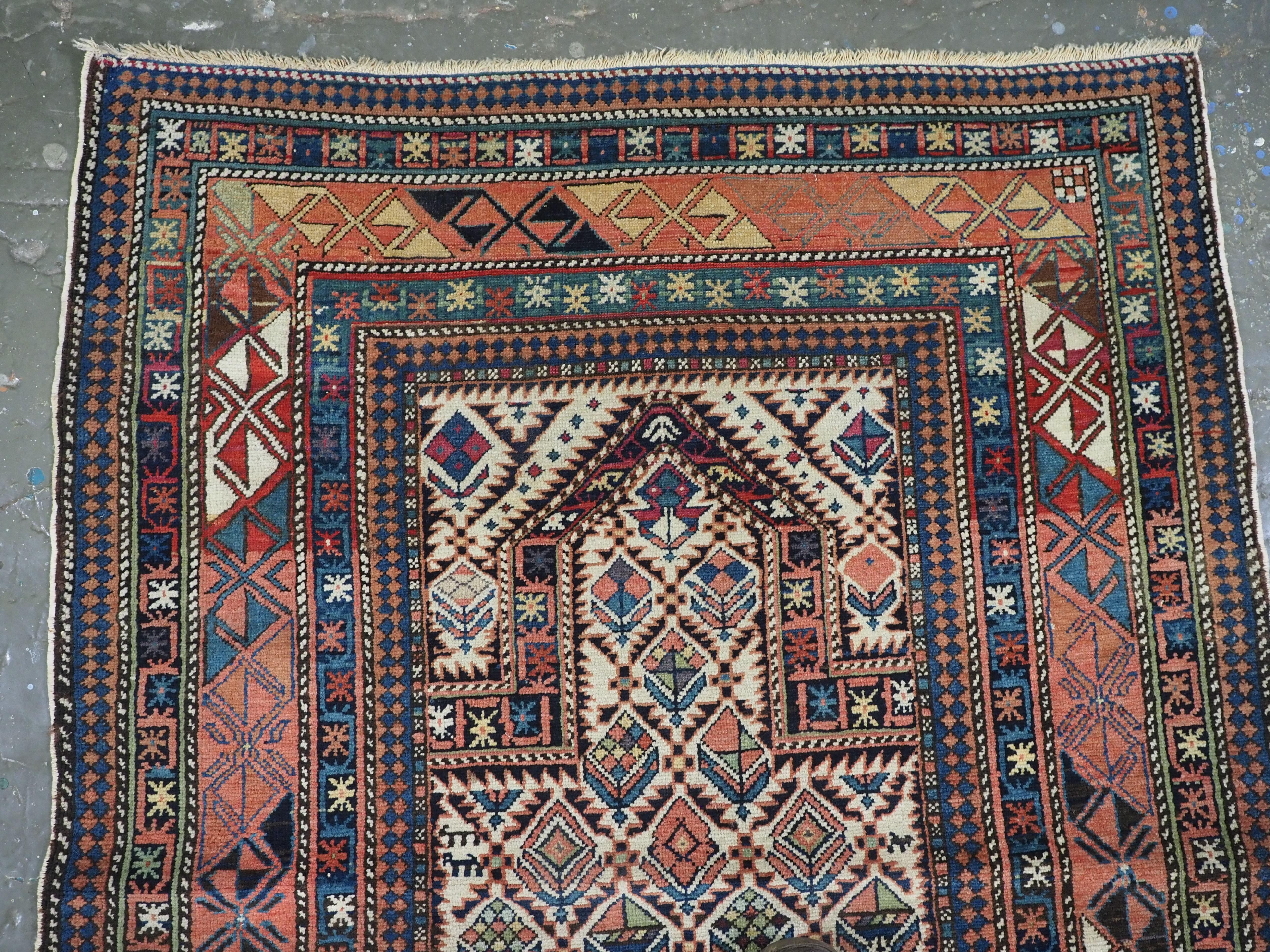 Size: 4ft 6in x 3ft 5in (137 x 103cm).

Antique Caucasian Dagestan prayer rug with floral lattice on an ivory ground.

Circa 1880.

A good example of this well known group of prayer rugs, this rug has excellent soft colour and is of a small