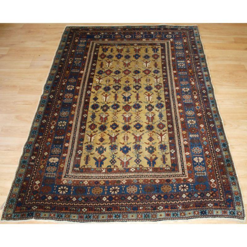 Antique Caucasian Erivan rug with interesting repeat design on a scarce yellow ground.

A very good small Erivan rug with a repeat angular design on a soft yellow field. The rug has multiple floral rosette borders including a very light indigo