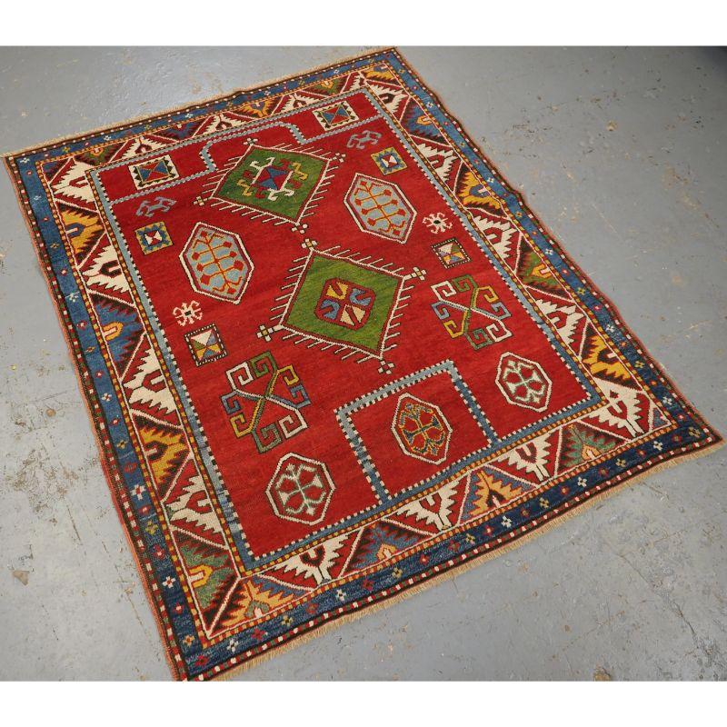 Antique Caucasian Fachralo Kazak prayer rug with outstanding colour and condition.

A beautifully drawn rug with excellent clear colours, there are two green diamond shaped medallions in green on a clear red field. The border is beautifully drawn