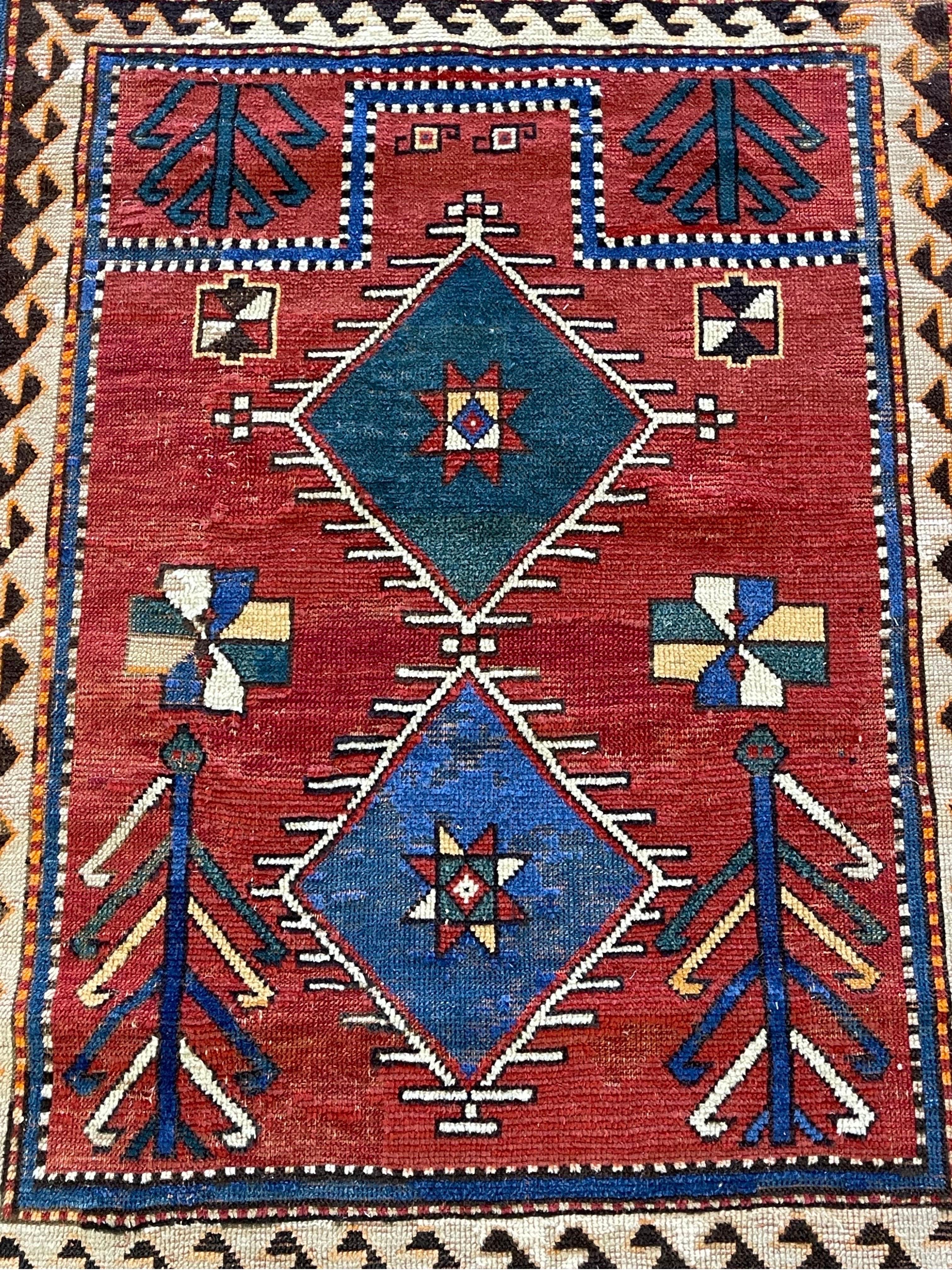 A beautiful Caucasian Fachralo Kazak, with two medallions decorated with stars and flanked with tree of life design this rug was handwoven in the town of Fachralo n of Lori Pamback and just southwest of Bordjalo. Fachralo Kazaks are almost always