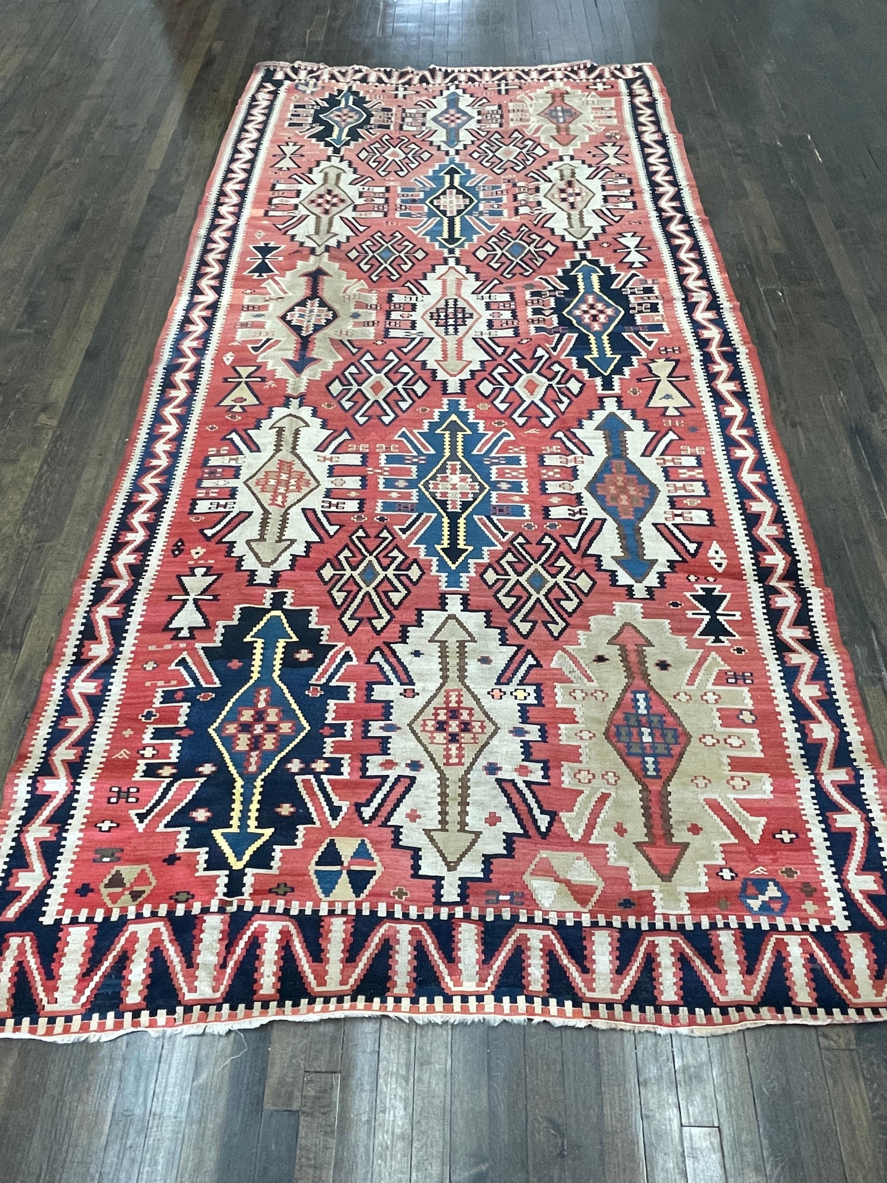 This rug is a flat woven kilm made in Shirvan area of caucasus region. Flat woven rugs are hand-loomed textiles with a flat surface-without pile-which present a relatively two dimensional surface. their basic structure is a plain weave which results