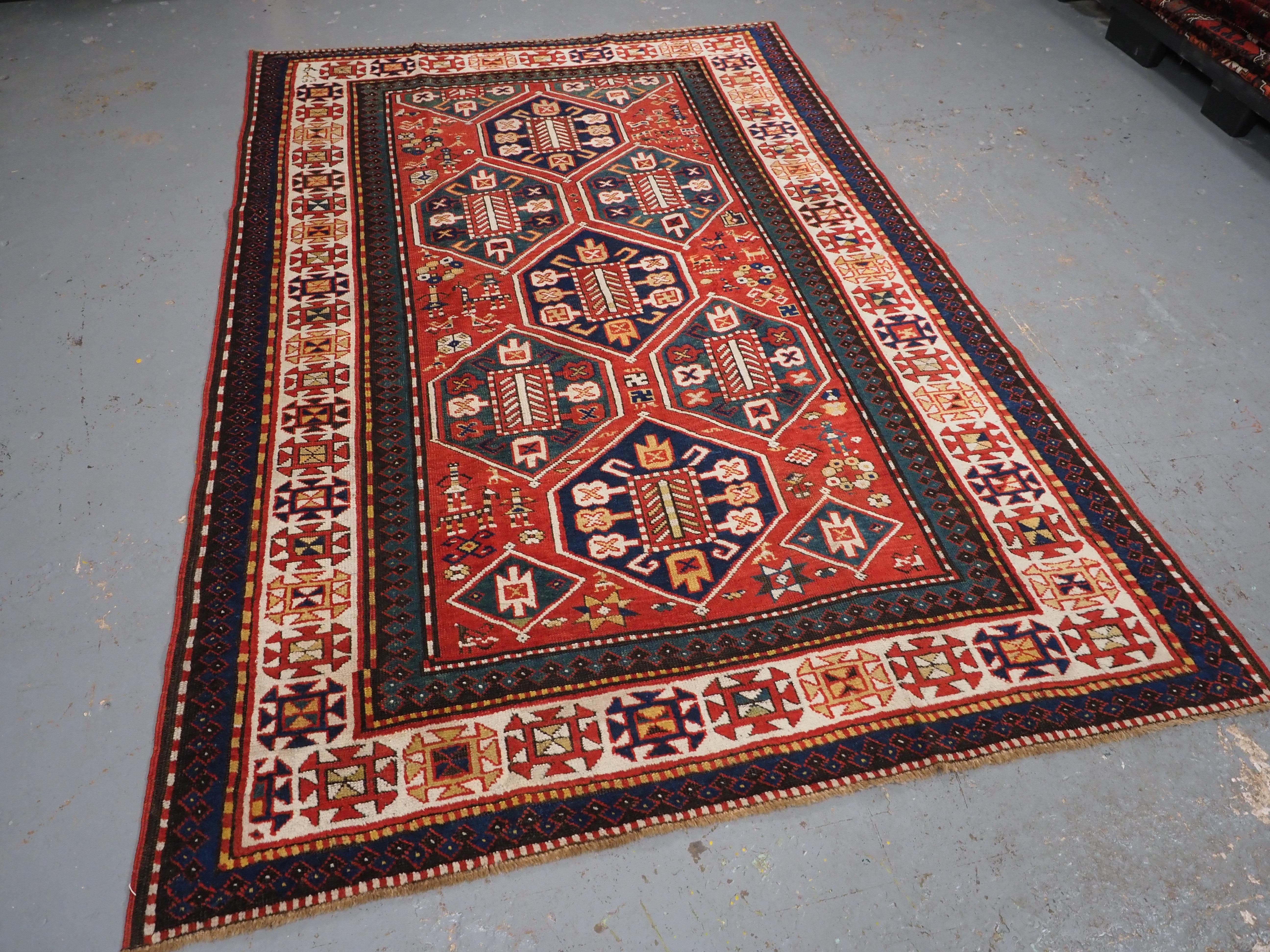 
Size: 7ft 9in x 5ft 1in (235 x 155cm).

Antique Caucasian Gendje rug with wonderful folk art design.

Circa 1890.

A truly outstanding rug with classic diamond medallion design on a madder red ground. The field is filled with illustrations of the