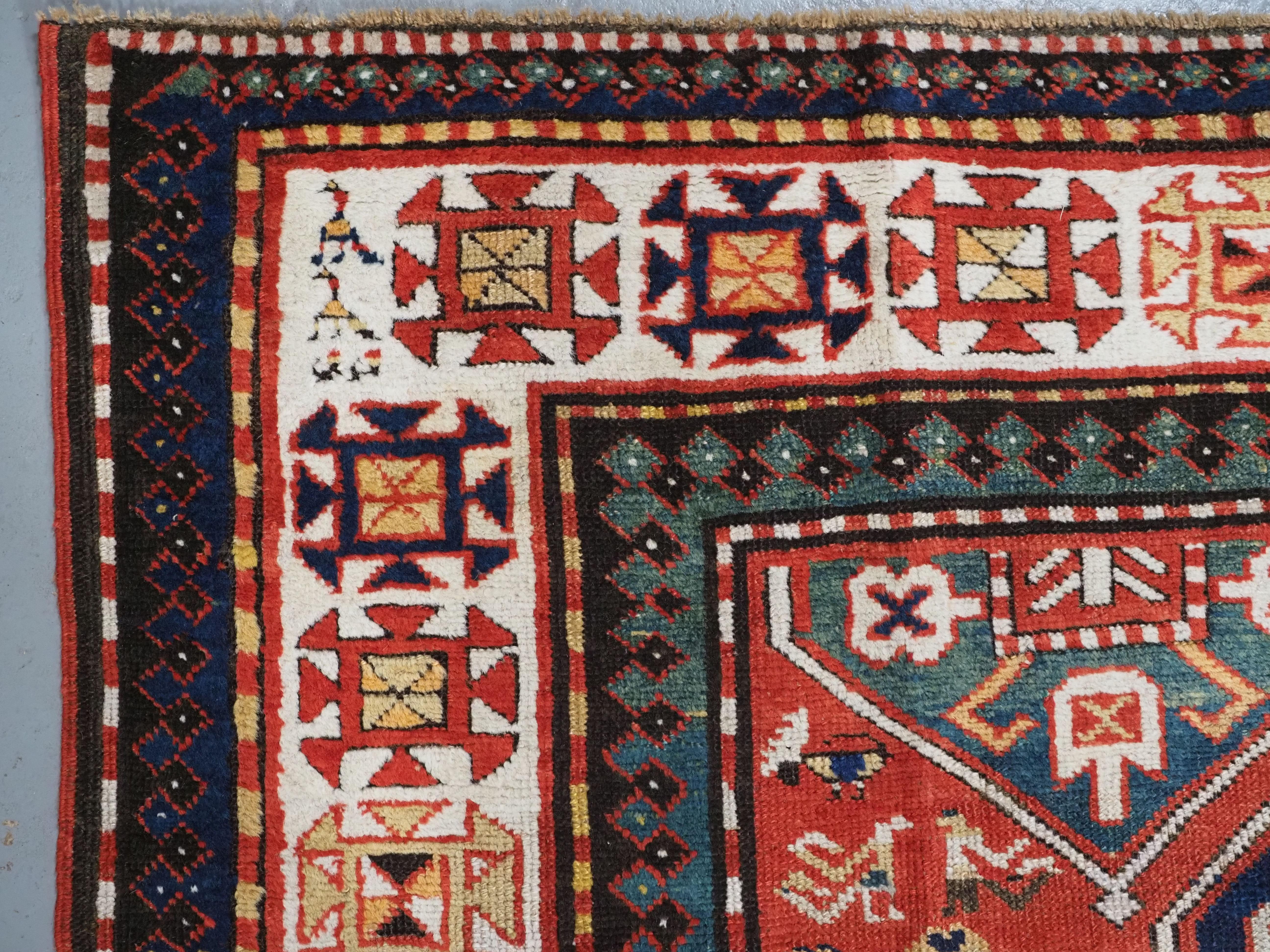 Wool Antique Caucasian Gendje rug with wonderful folk art design.  Circa 1890. For Sale