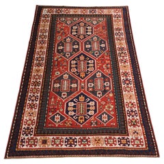 Antique Caucasian Gendje rug with wonderful folk art design.  Circa 1890.
