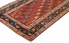 Antique Caucasian Genje Runner with Red, Green, Browns, and Blues Wool