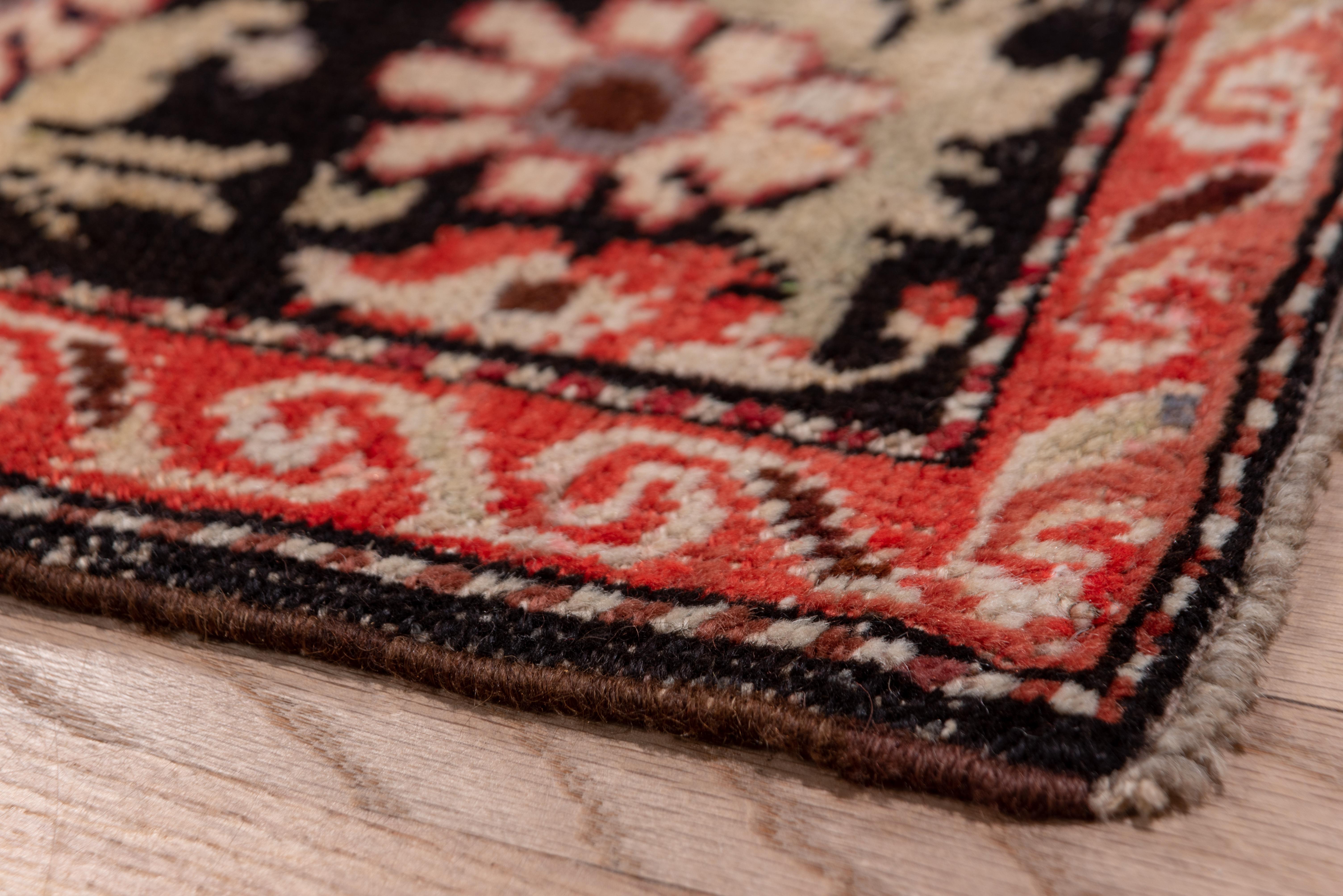 This South Caucasian runner shows a fairly well-spaced Herati design on a navy ground, with copious accents in teal and ecru. Bits of madder red detail the little palmettes. Brown border with bouquets. Wool foundation, medium South Caucasian village