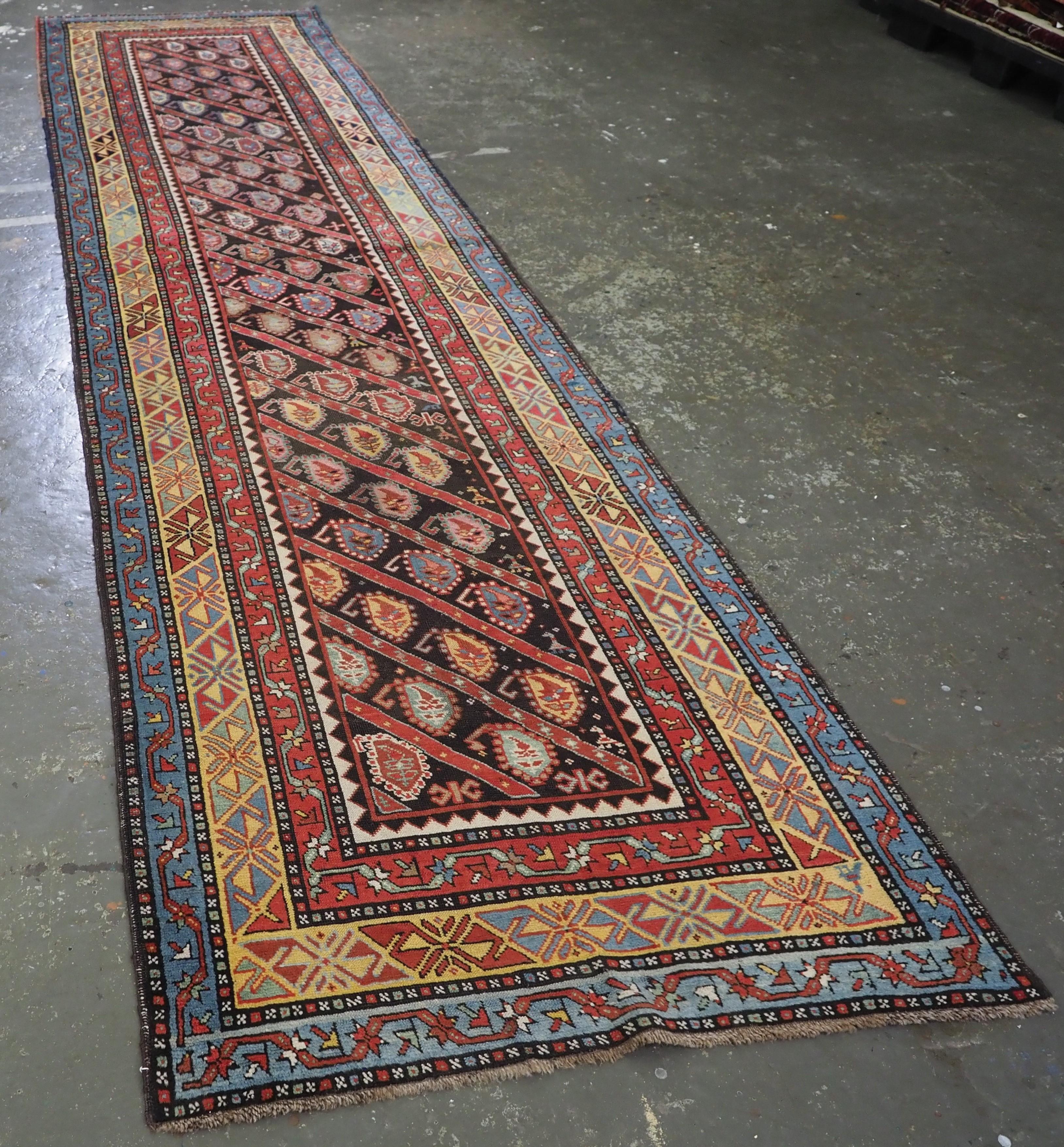 Size: 14ft 1in x 3ft 5in (430 x 104cm).

Antique Caucasian Karabagh region runner with all over diagonal boteh design.

Circa 1880.

A very good runner with diagonal rows of flowering boteh on a charcoal coloured ground. The rows of boteh are in