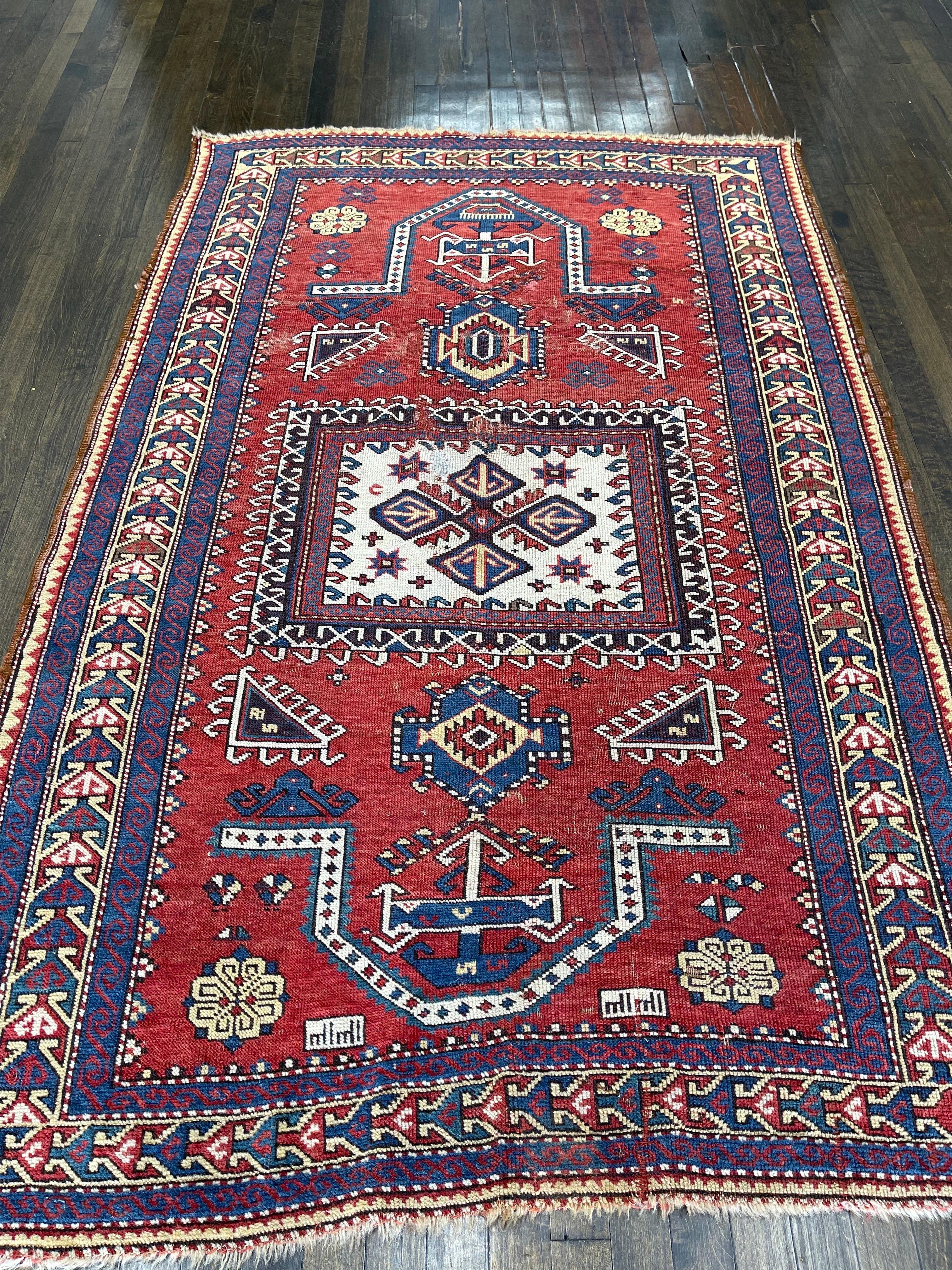 A very special and unique double Mehrab Karachov kazak created by artisan weavers of Karachove in south-western Caucus.The madder red field is decorated by ivory square medallion depicting the 