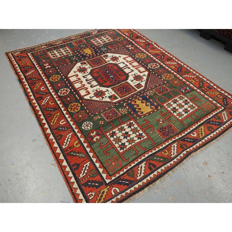 Antique Caucasian Karachov Kazak rug of classic design on a green ground.

A good example of a Karachov Kazak rug with the traditional large octagonal central medallion design. The central medallion is on an ivory ground, the four corners contain