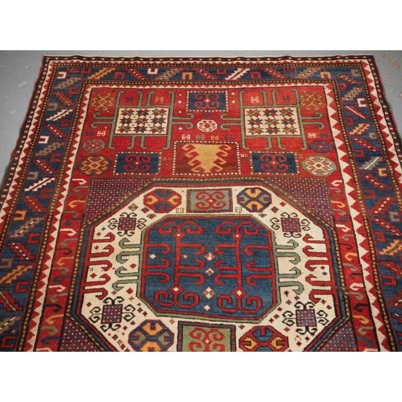 A good example of a Karachov Kazak rug with the traditional large octagonal central medallion design. The central medallion is on an ivory ground, the four corners contain the square and star design and include a very good soft green. Note the many