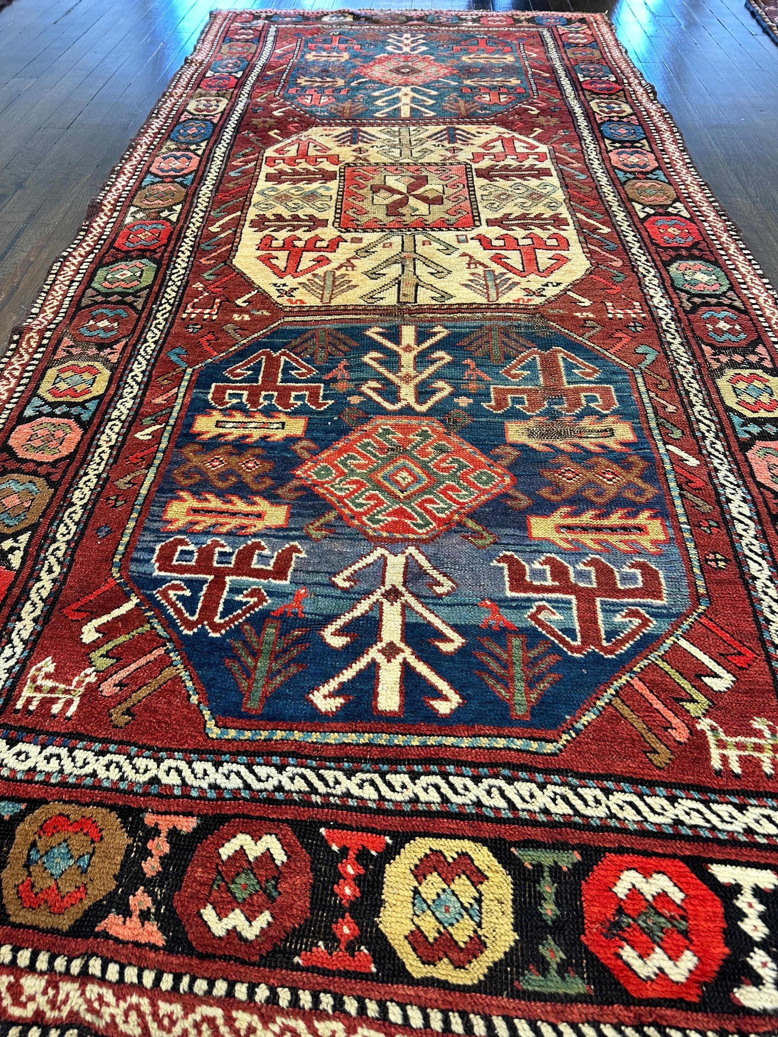 Attractive and very colorful  Caucasian rug created in the Karachov region  featuring three octagon shaped medallions,two in pale green and the middle one with ivory ground.Within each of these medallions there are smaller medallions and other