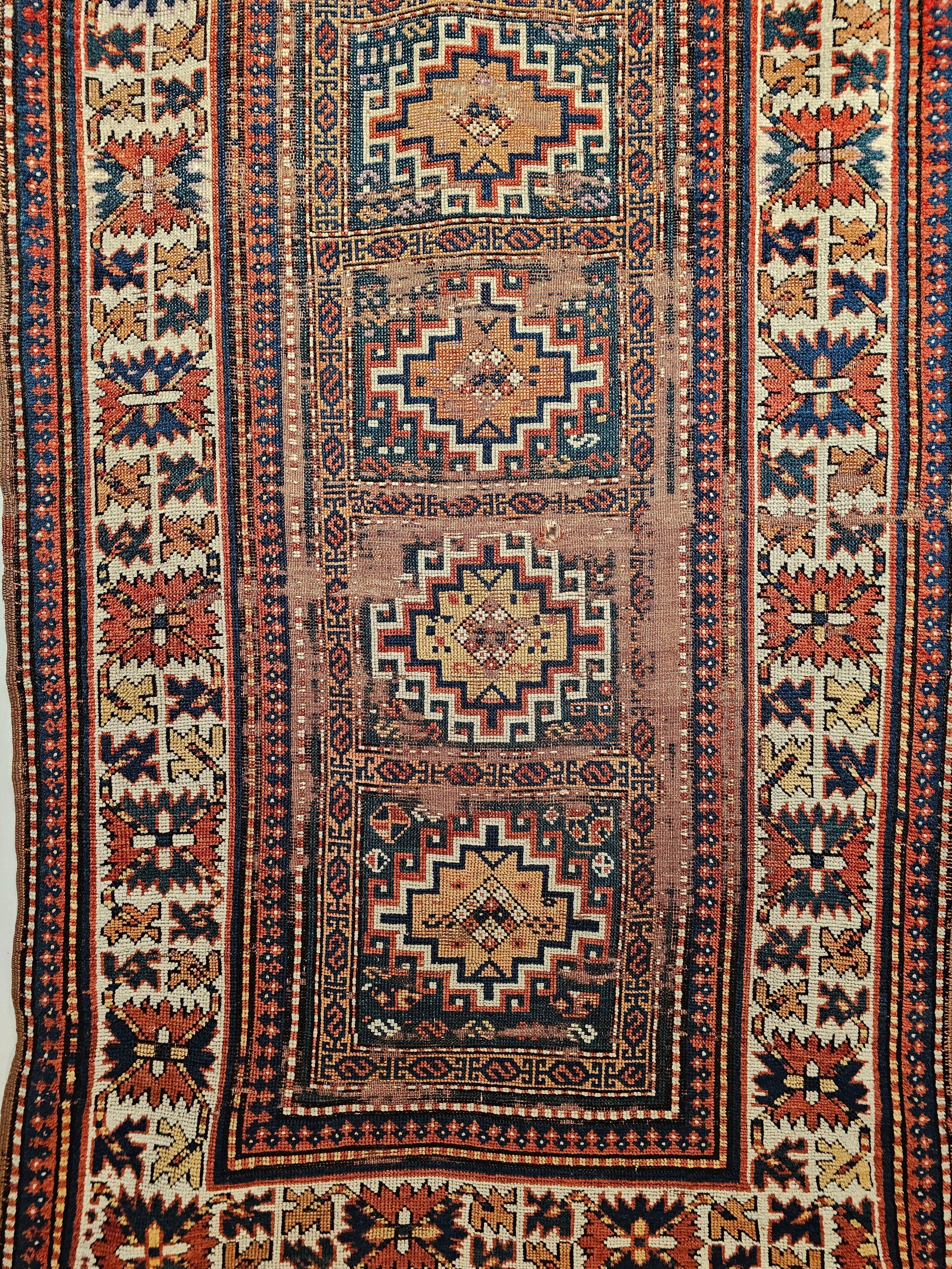 19th Century Caucasian Kazak in “Memling Gul” pattern in French Blue, Ivory and terracotta colors.  The main design consists of five “Memling Gul” medallions in a column each set in a French blue background. The medallion colors include brick red