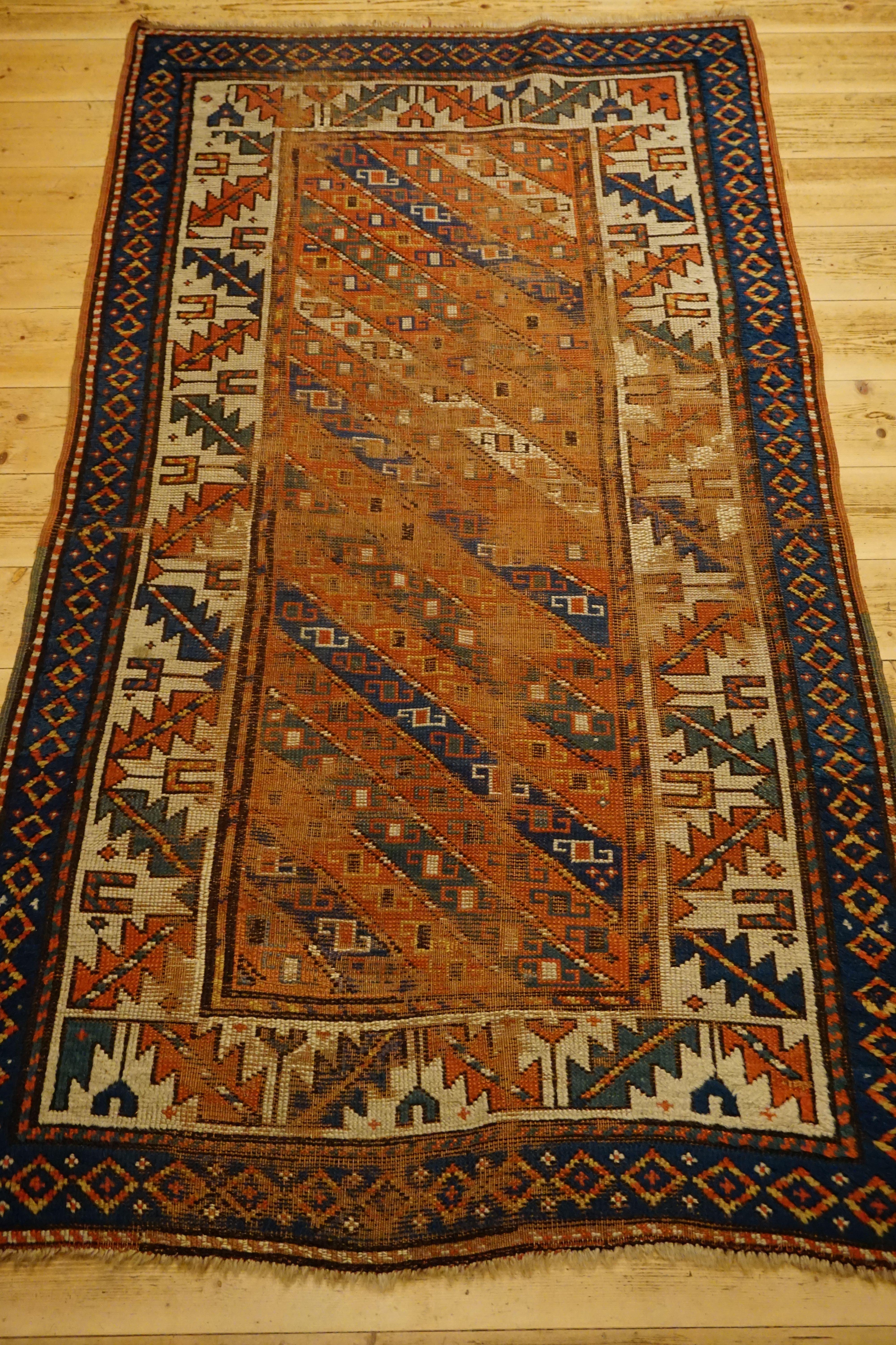 An antique Caucasian carpet
Beautifully interesting piece with bar star
Age: circa 1890.
Dimensions: about 1.00 x 1.74 meters
Material: Wool on wool with natural colors.
Condition: Relatively good for old age and okay.
Intertwining