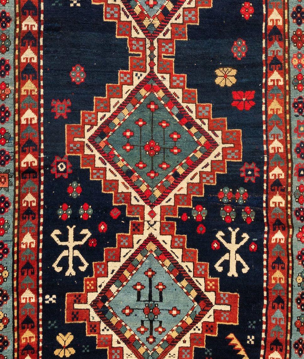 This lovely antique Caucasian Kazak carpet measures 4.9 x 7.3 ft and is from circa 1900s-1910s.

 